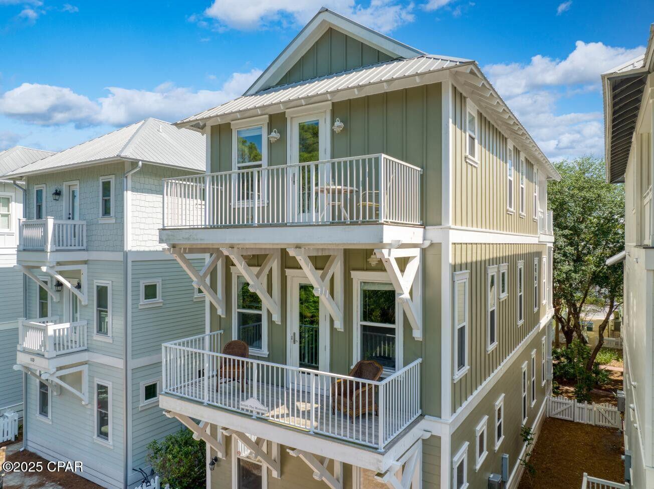 Welcome to 115 Cottage Court, YOUR COASTAL DREEAM HOME WITH GUARENTEED INCOME! Are you looking for a beach escape that works for you, even when you're not there? Look no further than this beautifully designed three-story coastal gem that's as charming as it is functional. Situated in a sought-after beachfront community, this property isn't just a home; it's an investment opportunity with an established income stream. Captivating Design and Features- This home boasts a stunning muted green facade, complemented by crisp white trim that surrounds its many windows and doors.    The modern metal roof and vertical siding add a contemporary touch, while the inviting balconies on the second and third floors, complete with decorative brackets, offer a warm and welcoming outdoor space perfect for enjoying the coastal breeze. Inside, you'll find four spacious bedrooms and four bathrooms, each crafted with attention to detail and professionally decorated. Each room is designed to include ample light and space, making it the perfect retreat after a day at the beach or exploring the area. A Community Packed with Amenities - Living in this community means more than just enjoying a beautiful home. The neighborhood offers private beach access for those sunrise walks and sunset picnics. Community swimming pools, tennis courts, and a fully-equipped gym ensure you have plenty to do, while the on-site restaurants mean you don't have to travel far for a great meal. Investment Opportunity - One of the key selling points of this property is the guaranteed income. With a lease agreement already in place under a reputable property management company, you can expect a steady net income of $6,800 per month. This makes the home an ideal choice for those looking for a vacation rental investment with immediate returns, a second home, or even a retirement spot that pays off years down the line. The Perfect Fit - Whether you're an investor searching for a property that promises consistent returns, someone looking for a second home to make unforgettable memories, or planning for the perfect place to spend your retirement, this home meets all those needs. The professionally designed interiors and well-maintained exteriors ensure it stands out in a vibrant neighborhood. With so much to offer, it's no wonder this property is not just a place to live but a destination to experience life at its fullest. Reach out today to explore this exciting opportunity and make it yours.