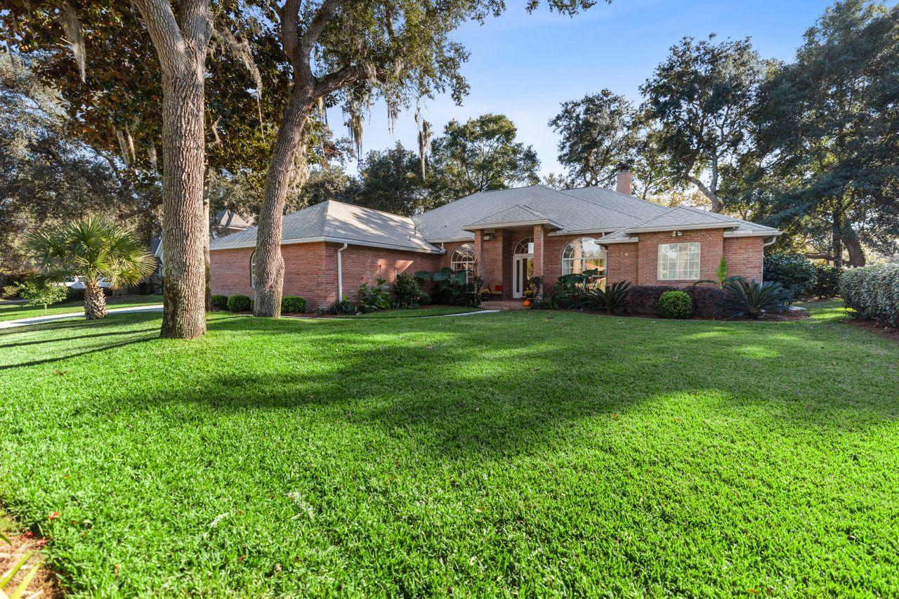 Beautiful golf course home in the gated community of Windward in Bluewater Bay. Peaceful and quiet cul-de-sac location with a gorgeous view of Lake Lido. An awesome new heated inground gunite pool overlooking the 9th tee box of the Bay Course. Enjoy the huge screened back patio with bricked floor that opens onto the custom paved poolside outdoor patio, with plenty of space for grilling or entertaining. The large 33' by 18' pool also has a Badu swim lane jet for great workouts, or just enjoy sitting on the swim-out platform while the automatic pool vacuum keeps it sparkling clean. Amazing views, yet the lush mature landscaping and fencing also provides plenty of privacy. The community beach and pier is just a short stroll down the street, perfect for fishing or watching the sunset. This home features beautiful Cali bamboo flooring with high ceilings accented by handsome crown molding and a beautiful natural gas fireplace in the open living room that leads into a lovely, updated kitchen with new cabinets, granite countertops, and stainless appliances to include a natural gas stove and wine fridge. There is also a formal dining room with breathtaking lake views.  And French doors lead off the living room into an office that overlooks the lake as well. The three bedroom, two and a half bath home is a smart and practical split floorplan. This lovely home really does have it all!