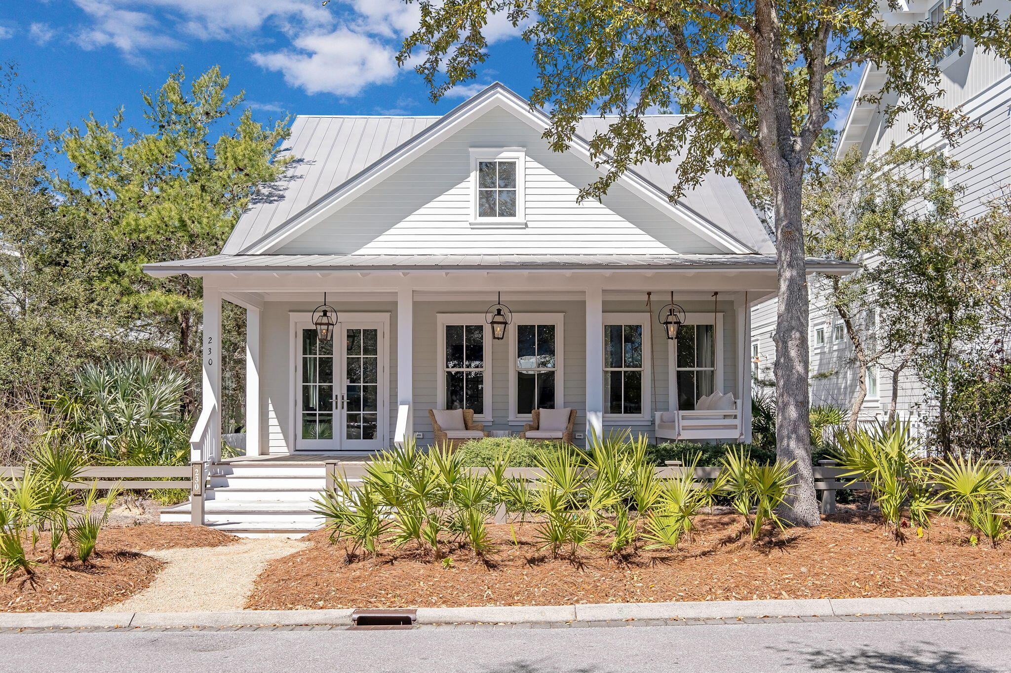 230 Needlerush is an immaculate home in the ever popular beachside community of WaterColor. The home has been completely reimagined and now features a layout that flows seamlessly from one room to the next. The new design elements, finishes, fixtures and artwork create a home that is the epitome of coastal chic; luxurious yet comfortable. No surface was left untouched during the process. The front porch welcomes you into the great room featuring shiplap walls, custom beams and local artwork. Light washed wide plank hardwood floors along with custom white drapes add to the light feel of the home. The Currey & Co. chandelier is a beautiful accent piece for the dining area.  The Fulgor Milano appliances are a unique combination of style and function. This room is set up perfectly... for enjoying time at the beach together. 

 Just off the main living area you find a half bath and hallway leading to the first floor guest suite and first floor master suite.  Both en suite bathrooms feature beautiful glass showers and elegant vanities and tile work. Beautiful lighting in these rooms from Visual Comfort and Serena & Lily accent the overall style of the home.  

Just outside of these rooms is the oversized screened porch with a built-in fireplace that is set up perfectly for outdoor living.   
The second level features a second living area/TV room and a large guest bedroom. Built in bunks along the hallway provide additional sleeping accommodations on this floor; perfect for those extra guests. The carriage house is accessed either via private stairs or over an attached walkway from the second floor of the main house. The carriage house easily accommodates guests or family members looking for more privacy but who still want comforts such as a kitchenette, sitting area and separate bedroom and bathroom. This beautiful addition adds an element not found in many homes this size in WaterColor.  The full sized two car garage below is yet another bonus for this home making it suitable for a number of uses from full time residence to income producing vacation home.  

Location wise the home sits across the street from one of many pocket parks found in WaterColor and just around the corner from the Frog Pool and park area; a favorite of WaterColor residents and visitors.  The WaterColor Beach Club featuring multiple pools and restaurants- all looking out over the dunes at the Gulf- is an easy walk, bike or golf cart ride away.  WaterColor is second to none when it comes to the amenities it offers residents and guests.  You have all of the world class WaterColor amenities at your fingertips with the additional bonus of the idyllic New Urbanism community of Seaside just down the road.  

This is the beautiful WaterColor beach home you have been waiting for.