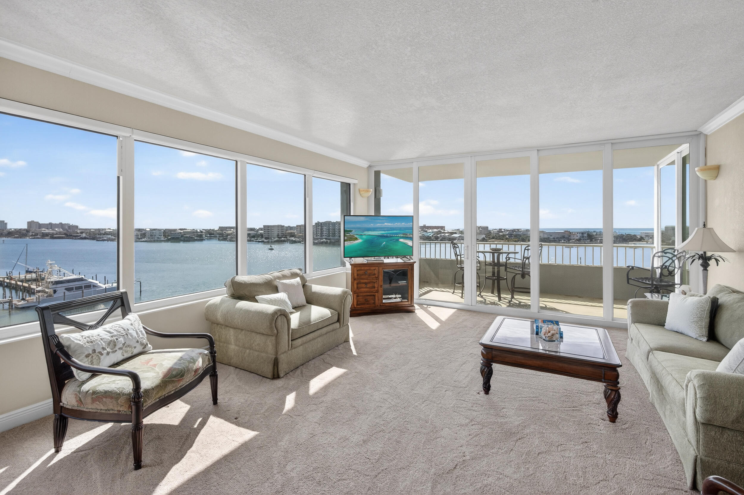 You MUST tour this home! Photos can not accurately capture this Waterfront Retreat. Highly desirable 3BR/3BA condo in Destin Yacht Club featuring TWO Deeded Boat Slips (35' and 55'), a rare find! This spacious, corner/end residence is filled with natural light and features breathtaking views of the Harbor and the Gulf. The split-bedroom plan offers much privacy for guests with their own private bath. The Living/Dining space boasts almost floor-to-ceiling windows with automatic filtering shades. Enjoy gorgeous views in your primary suite from sunrise all the way to twinkling harbor lights, then with one click, your shades can be lowered until morning. The 3rd BR is now an office, but with harbor views and a closet, it's easily converted to a bedroom. All this + Impeccably Maintained! Access your private gate to the HarborWalk Village and be in the center of entertainment, live music, restaurants, local fishing culture, holiday festivities, and more. Destin Yacht club is a gated waterfront community and offers many  upscale amenities such as pool, fitness, expansive owners' lounge, game room,  additional storage, outdoor bar area and fish cleaning stations.  The condo is sold fully furnished and is ideal for full-time living or second home (No rentals allowed).