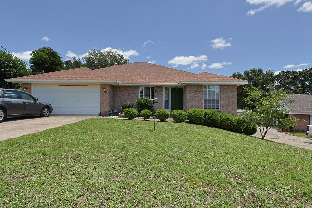 This charming brick home offers 4 bedrooms and 2 bathrooms with a spacious open split floor plan. The living room features vaulted ceilings and chair railing, creating an open and inviting atmosphere. The kitchen includes a breakfast bar, tiled backsplash, and wood laminate flooring, with durable flooring continuing throughout the main living areas.

Additional features include an attached 2-car garage, an indoor laundry room, and a large open deck overlooking a fully fenced backyard, providing ample outdoor space. The property is located in Antioch Estates in Crestview, south of Interstate 10 and approximately one mile to I-10 access. Conveniently located near Eglin Air Force Base and within the Okaloosa County School District.