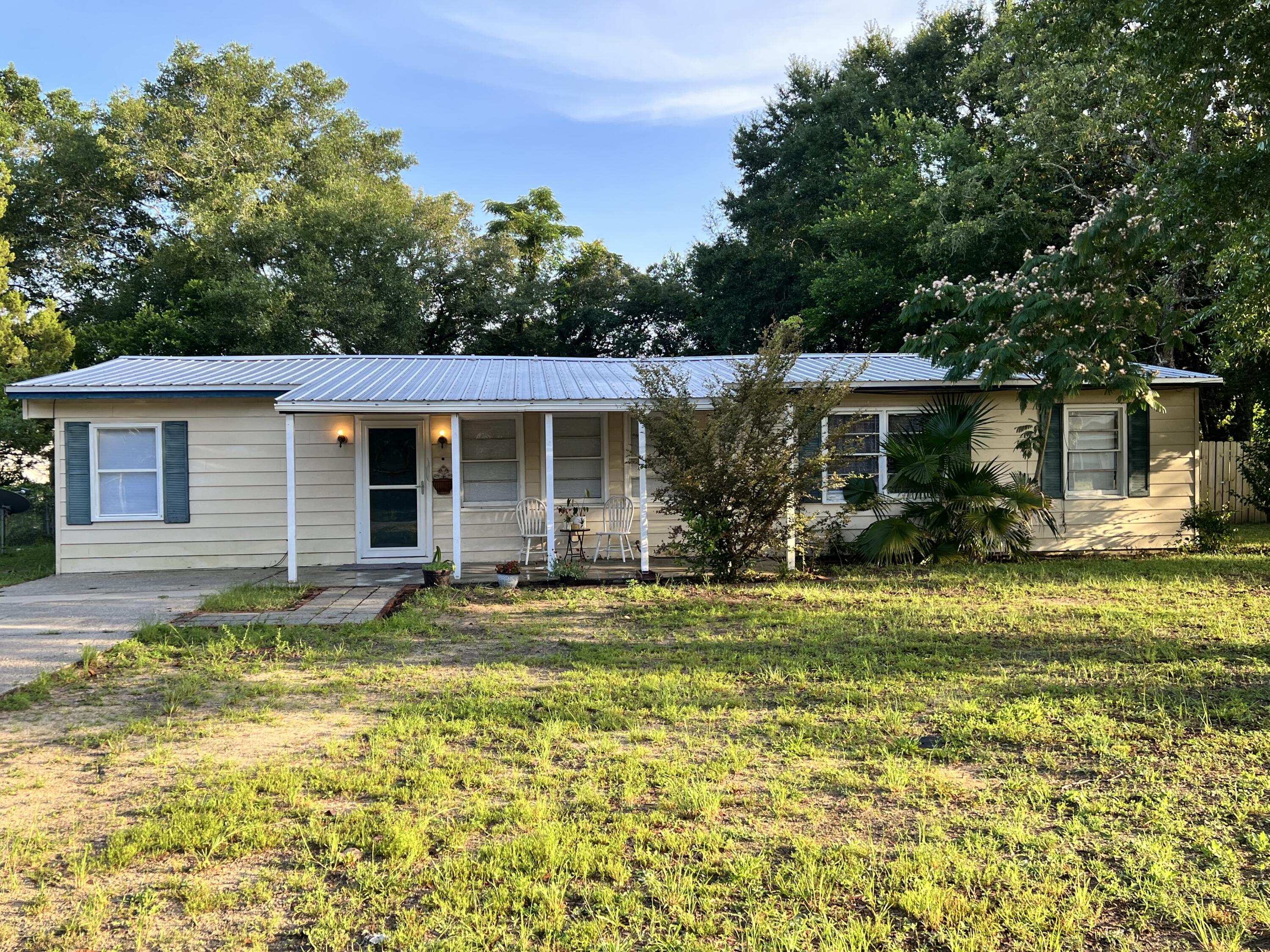 This adorable 4 bedroom/2 bathroom is minutes away from Eglin Air Force base back gate. Home has a metal roof 2016 and SOLAR Panels. The AC and hot water heater were replaced in 2020. The electric panel box was replaced in 2019. Seller has put new carpet in all the bedrooms and living room. There is a large utility/laundry/pantry room that has lots of storage. Large back yard with room to store your RV and/or boat. Seller to pay off solar panels at closing approx $25,000. Great price for a four bedroom home!