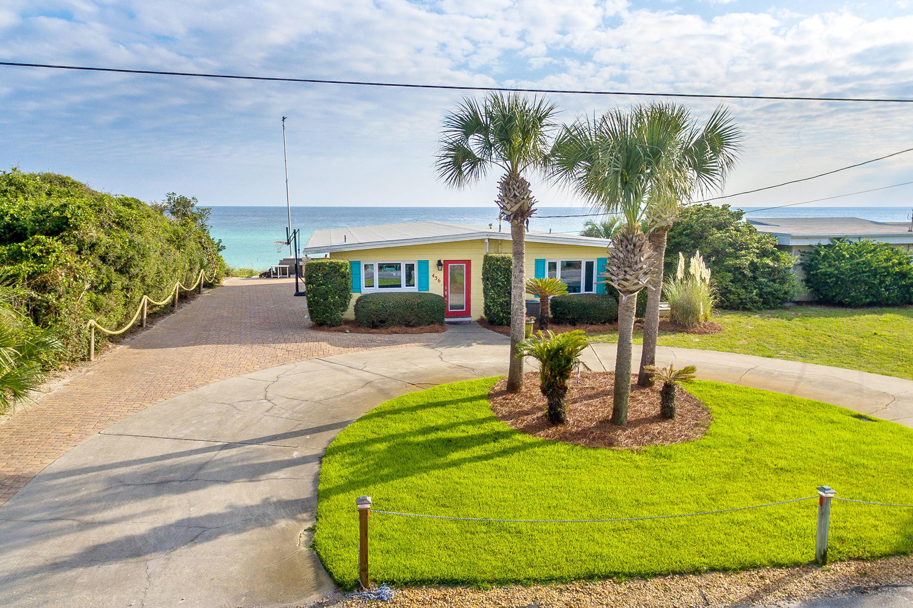Under contract with a 72 hour kick-out clause. For those who crave the simplicity in beachfront living, just steps from the Gulf of Mexico, this Blue Mountain Beach property is for you. Poised on top of a sand dune at one of the highest coastal elevations in Florida with 75-feet of water frontage, this classic single-floor concrete block cottage, built in the 1960s, embraces its era with original terrazzo floors, exposed wood timbers and vaulted ceiling. The bright open kitchen boasts modern white appliances, and updated electrical wiring allows modern lighting to gracefully illuminate the home. The spacious great room with built-in shelves, flows easily to the wide Trex deck and beach, offering abundant opportunities for entertainment. The master bedroom and adjacent bonus room open to the deck where one will enjoy expansive view of the beach and Gulf of Mexico. The generously sized guest bedroom can accommodate bunk beds or 2 queen beds. The home offers a full bath, a half bath, as well as a uniquely private, outdoor claw foot bathtub and shower. A shed and yard space provide storage for kayaks and bicycles. 3 more key features of this property are the permitted seawall, shared dune walkover, and nearly a 0.4 acre lot size, which allows for plenty of parking and expansion of the home. There's no better place to enjoy or invest in beachfront living than right here.