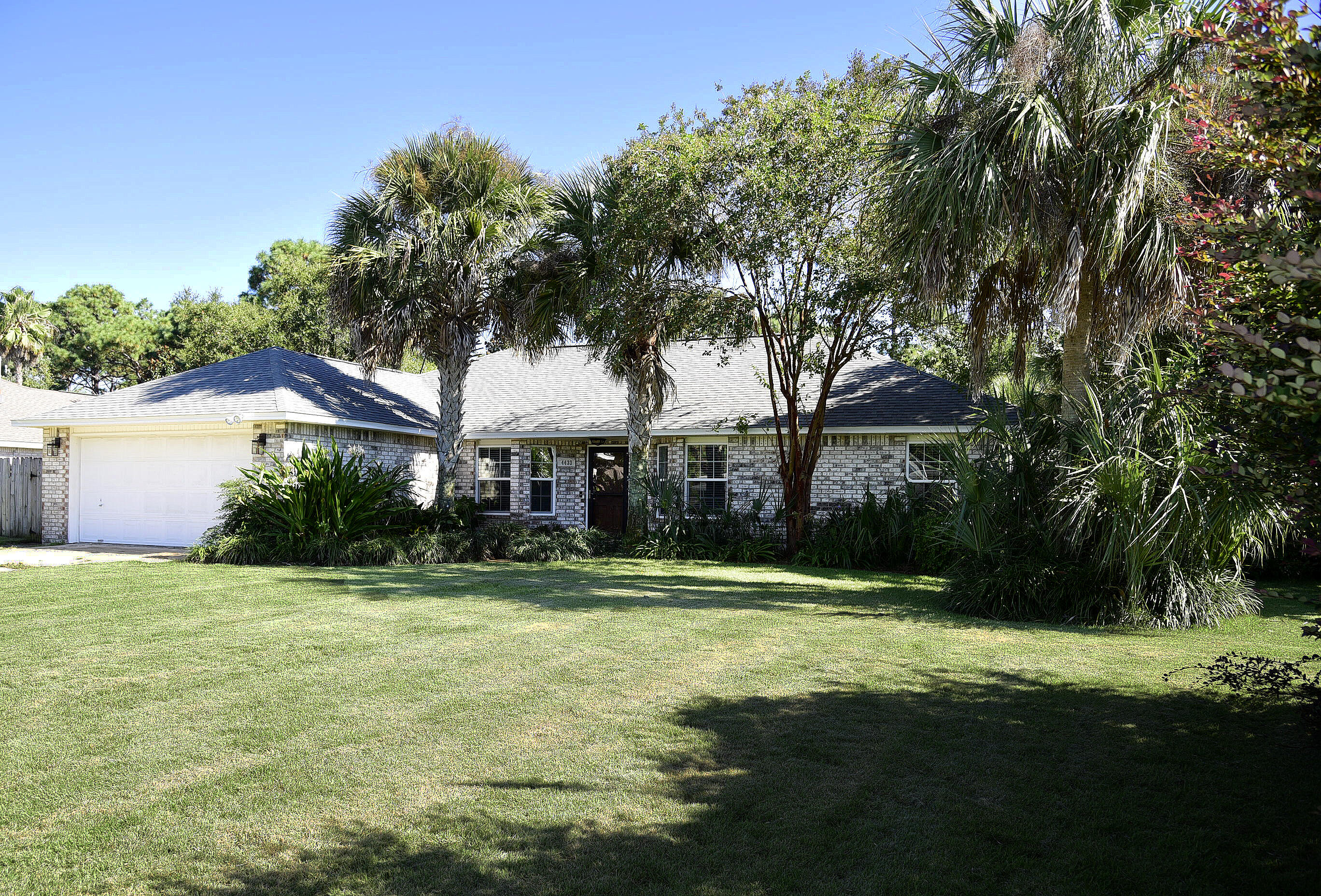 Gorgeous COMPLETELY RENOVATED all brick home with a pool in highly desired Raintree Estates! No expense spared in this beauty! High-end luxury vinyl plank flooring throughout. This chic 3 bedroom, 2 bath home with an office is everything you've been looking for and more. Upon entry, your eyes will be drawn to the cathedral shiplap ceilings and wooden beam with designer lighting. To your right, through glass pane French doors is a dedicated office with built-in cabinets, shelving and lots of natural light. From there, you'll enter the spacious open living room with a custom-tiled and trimmed gas fireplace and double glass doors with custom drapery looking into the resort style backyard.  Off the living room is a eat-in kitchen area with plenty of space for a large dining set. The luxuriant The luxuriant kitchen will 'wow' you with the custom "anchor blue" cabinetry, quartz countertops, subway backsplash, large single bowl sink with matching stainless-steel appliances, including a gas range for the culinary enthusiast. The master bedroom is off of the kitchen, keeping with the coastal design of the home with a navy-blue accent well providing depth and texture to the already substantial sized room.  The ensuite adorned with marble tile, double vanity, soaking tub, separate tiled shower and walk-in closet. On the other side of the home, you will find 2 bedrooms, each unique as well.  Custom shiplap wall with shelf in one room, inviting view of the backyard in the other room.  Between the 2 bedrooms is a well-appointed guest bath with octagon tile flooring and dark grey undermount single sink vanity with Carrara engineered marble. We've saved the best for last...the backyard...the tropical oasis awaits! Custom Gunite pool with fountain, surrounded by brick pavers, lush landscaping with scores of tropical plants and trees, sand firepit and plenty of privacy. The scenery is just as breathtaking in the evening as each grouping of palm trees is lit up with an automatic timer. 

Raintree Estates boast an optional membership HOA of only $150/year and allows access to 2 private parks; a fully secluded Woods Park with wooded walking trails, soccer field and a baseball diamond.  The Beach Park is equally as impressive with a community dock, kayak launch, pavilion, BBQ grill all with access to the Choctawhatchee Bay.  This waterfront community is conveniently located just 6.5 miles to Destin's world-class beaches, restaurants and shopping.