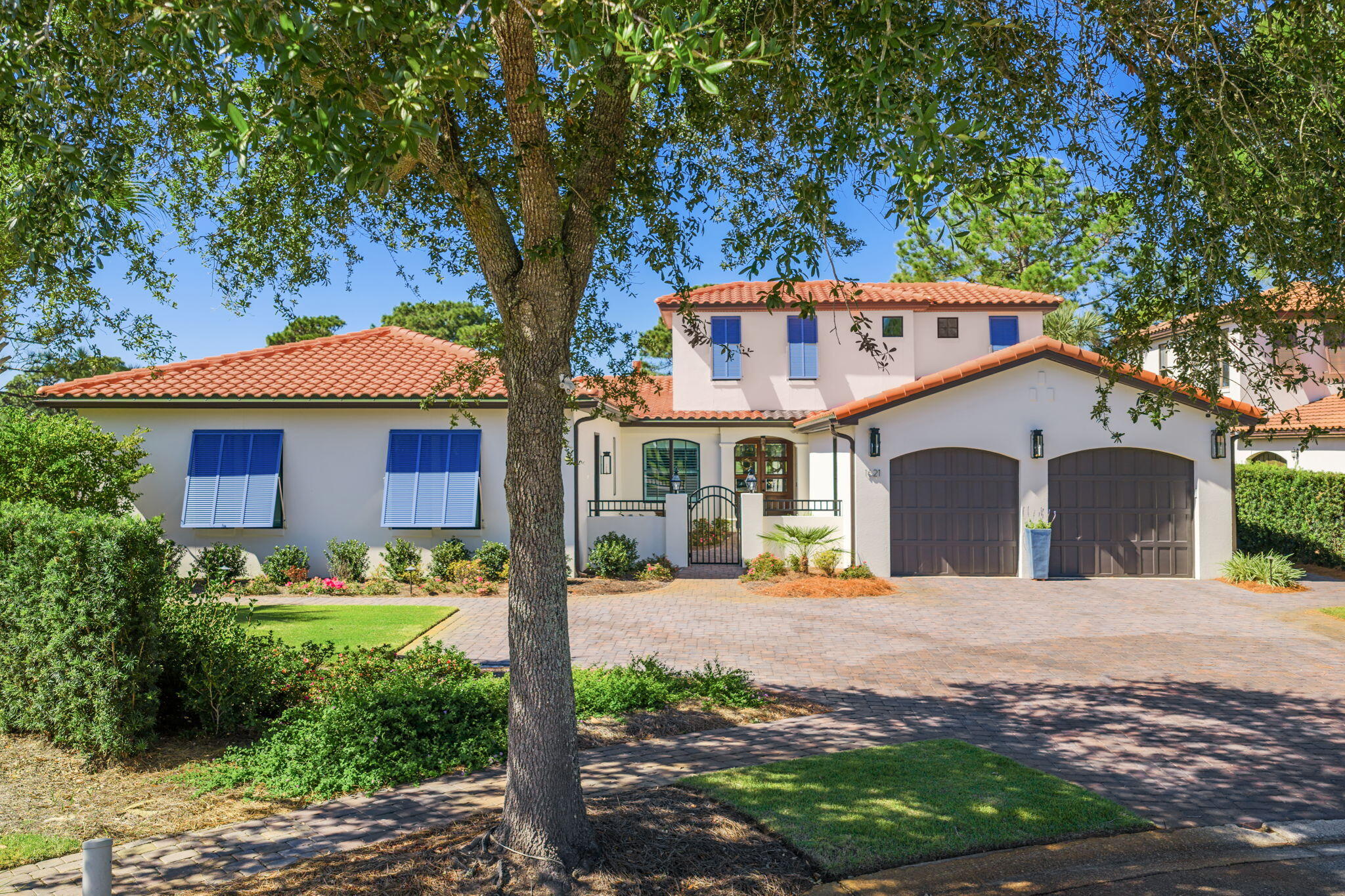 STUNNING MULTI-GENERATIONAL LIVING HOME ON A SPECTACULAR LOT! This fabulous property just underwent a complete renovation, including a new roof and windows, 2 new HVAC units, 2 new tankless hot water heaters, new landscaping and pavers as well as a new addition including a MIL suite with its own separate entrance. As you enter through the private courtyard, you will be amazed by the bright, open living area with floor to ceiling windows, giving you breathtaking views of the resort-style pool, lake, and golf course. The oversized chef's kitchen is an entertainer's dream. It includes plenty of storage, high-end appliances from Thermador and Wolf as well as an expansive 15 ft island, separate built-in bar area and a large walk-in climate controlled wine cellar. A convenient home office with  plenty of natural light overlooks the courtyard. The primary suite, located on the first floor boasts amazing storage with 4 walk-in closets and a bathroom beyond compare with his and her vanities, a huge low curb shower and a luxurious soaking tub. The mother-in-law suite with a gorgeous oversized bathroom with separate shower and soaking tub has a large, attached room that can be used as a separate living space or additional storage area. Also on the main floor is a third bedroom, which is currently being used as an office and exercise room. Upstairs, you will find 2 additional bedrooms with amazing natural light and private baths. Plenty of parking is available for your guests with the 2.5 car garage and large paver driveway. A convenient EV charger makes charging electric vehicles quick and easy. The fabulous backyard is a wonderful setting to entertain your guests and enjoy beautiful sunsets and the Baytowne fireworks. In addition to the pool and hot tub, an outdoor kitchen includes a built-in gas grill, refrigerator and Green Egg. There is even a turf area outside the master bath for your furry friends. Come see this amazing, move-in ready dream home!