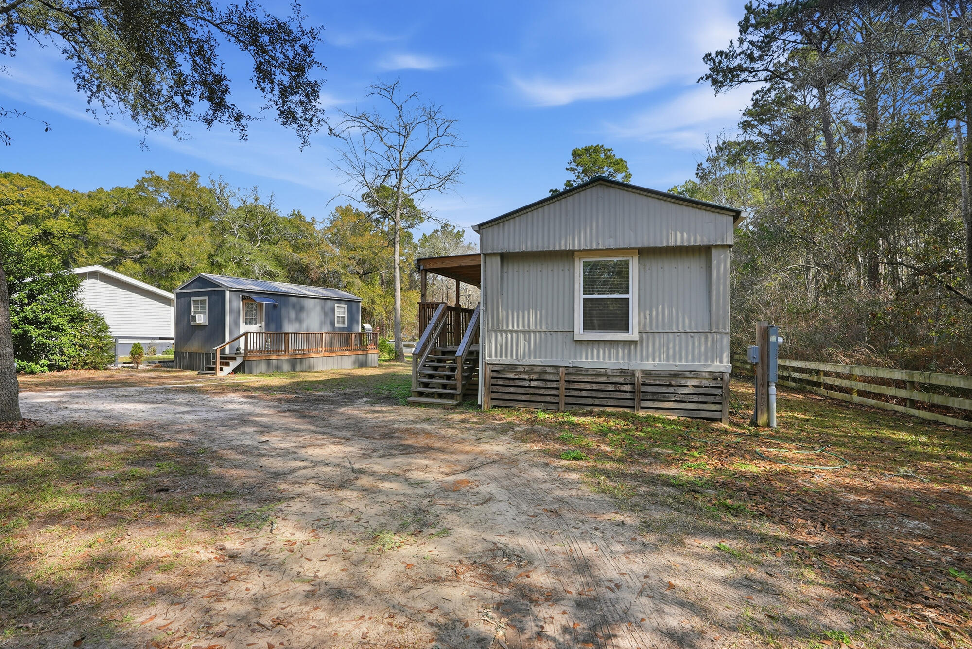 Versatile income-producing property located approximately 0.1 mile from Black Creek Lodge & Marina and just 20 minutes from the white-sand beaches of 30A. The main residence is a 2-bedroom, 2-bath mobile home complemented by a separate 1-bedroom, 1-bath tiny home—ideal for extended family, guests, or additional rental income. Both homes are tenant-occupied with long-term leases in place, offering immediate cash flow at $2,500/month. Whether you're seeking a family vacation retreat with extra space or a smart addition to your rental portfolio, this property delivers flexibility, location, and upside. Enjoy nearby boating, fishing, and coastal living while investing in one of the area's most desirable and fast-growing markets.