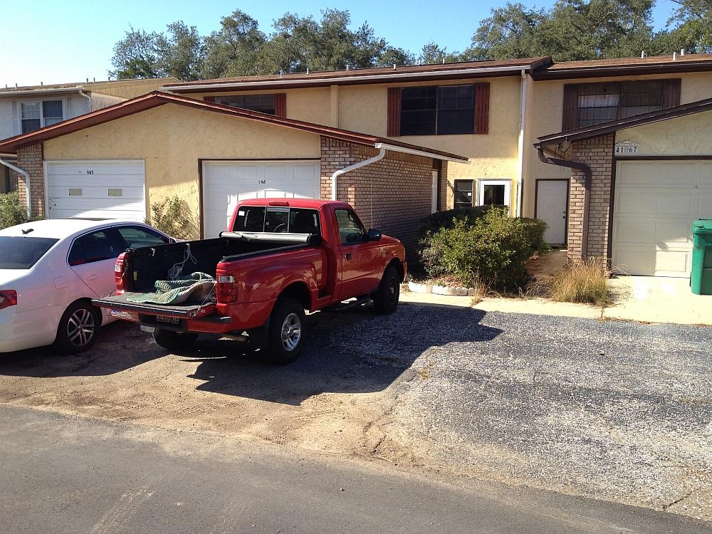 Ideal location for anyone stationed at Eglin Air Force Base! This spacious three bedroom, two and a half bath townhouse has storage space for days. Start with the good sized single car garage with workbench, enter into the house to enjoy the large living room, large laundry room, wrap around kitchen, two pantries, and a half bath. Out back you'll find another storage room and the undefined back yard that opens into a huge grassed common area. Upstairs is one small bedroom, another good sized bedroom, a shared full bath and a huge master bedroom with its own private full bath. Call today because this house will not last long!