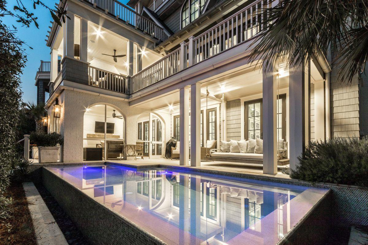 Casual elegance describes this thoughtfully designed four story beach home, a masterpiece of indoor/outdoor living. Architecturally designed for gathering family and friends; the premium lot location within the exclusive gated community of Watersound Beach allows for spectacular views of the dunes and Gulf of Mexico. Accordion panel doors in the living room and kitchen open wide to connect the interior living spaces with outdoor entertainment. All three floors and the fourth-floor tower enjoy open and covered deck spaces, perfect for sunsets, star gazing, and sunbathing. The gourmet kitchen showcases quality design with shiplap wall accents, lustrous granite, Dacor 6 burner gas stove and Sub-Zero Refrigerator/Freezer. Five bedroom suites, each uniquely styled, are spread among three floors for proximity to the common areas in the home. Convenient on each floor are living rooms, half baths, laundry facilities, ice makers and wet bars. Take a dip in the private heated infinity pool, or daydream on the coastal bed swing. Choose between two separate outdoor wood burning fireplaces, multiple lounging nooks with outdoor televisions, or the screened porch. On the way to the sugar white beach, check out the neighborhood pool and restaurant and stroll the boardwalk through treasured dunes. All this is right outside the garden gate of this exquisite beach home. On the practical side, the Nantucket-style exterior has mildew resistant paint, stone pavers, and a natural landscape needing minimal maintenance. HVAC units incorporate individual dehumidifiers for added comfort and performance, and the elevator services all three floors of the home. This is the ideal investment for generations of family gatherings and vacations.