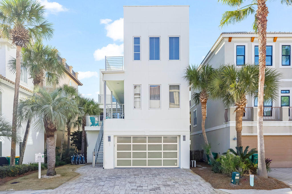 Located approximately 180 feet from the beach access and just two homes back from the Gulf in the guard gated community of Destiny by the Sea, this contemporary five-bedroom property can comfortably accommodate up to 14 guests.  

The first level includes a two-car garage, two bedrooms with private baths and a separate living room providing additional space for guests to relax.

The second floor includes the main living are with a chefs' kitchen framed by floor to ceiling windows for natural light.  The kitchen offers stainless steel appliances, custom cabinetry, white quartz countertops and a large island with seating.  The second level master suite provides Gulf views and multiple doors leading to the wraparound pool deck, an en-suite bath with a soaker tub and seperate shower. The third floor includes an additional living area with a Pac-Man arcade console, bunk room with en-suite bath featuring dual showers and a master suite that includes a soaker tub and separate shower.  Oversided windows and large sliding doors open to a balcony with a view of the Gulf and private pool below.

The rooftop deck provides expansive Gulf views along with two separate seating spaces for entertaining.