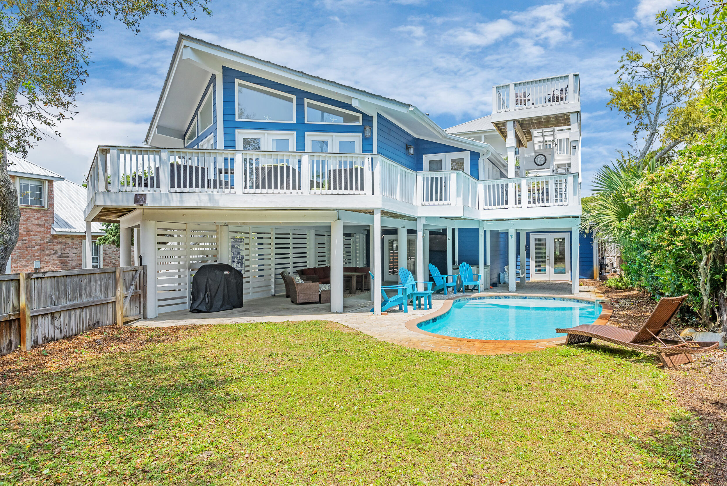 With an air of mid-century style, this charming South of 30A beach retreat offers privacy on a large lot, only moments from the Gulfview Heights Regional Beach Access. This property provides plenty of space for large groups to spread across—with 5 bedrooms, 4 bathrooms, two living areas, a second-floor deck that runs along the architecture of the home and leads to a crow's nest deck with a glimpse of the Gulf, and two fenced-in yards. One area is privatized in the front, surrounding the heated pool, the other is out back, with a patio-sitting area. Beautiful live oaks offer a parklike atmosphere in front. Indoors, enjoy an open living, dining and kitchen area with a vaulted ceiling and walls of windows. Downstairs is the second master suite and recreation room with pool table and wet bar. The home has two sizeable outdoor storage lockouts for beach gear; one is a small garage. With the large bunk room, this home can accommodate groups of up to 14.

At the end of Betty Street, turn left to enjoy the Gulfview Heights Beach Access, providing parking, restrooms, showers, sheltered picnic tables, and lifeguards during peak season. 95 Betty St is approximately 350 yards to the sand.

Betty Street offers privacy away from it all, with just 28 homes on large parcels and a dead-end, there will be limited drive-through traffic.

No HOA fees or added restrictions means freedom of ownership and opportunity for creative growth and expansion.

The home is just under 3/4 a mile to the shops and restaurants at the intersection of 393 and 30A, including, Papa Surf Burger Bar, Shunk Gulley, Growler's Garage (Craft Beer), Pecan Jack's Ice Cream, The Perfect Pig and other Gulf Place amenities. 

If you are looking for a South of 30A beach home with character and an incredible, private location, 95 Betty Street belongs on your list of must-see properties.