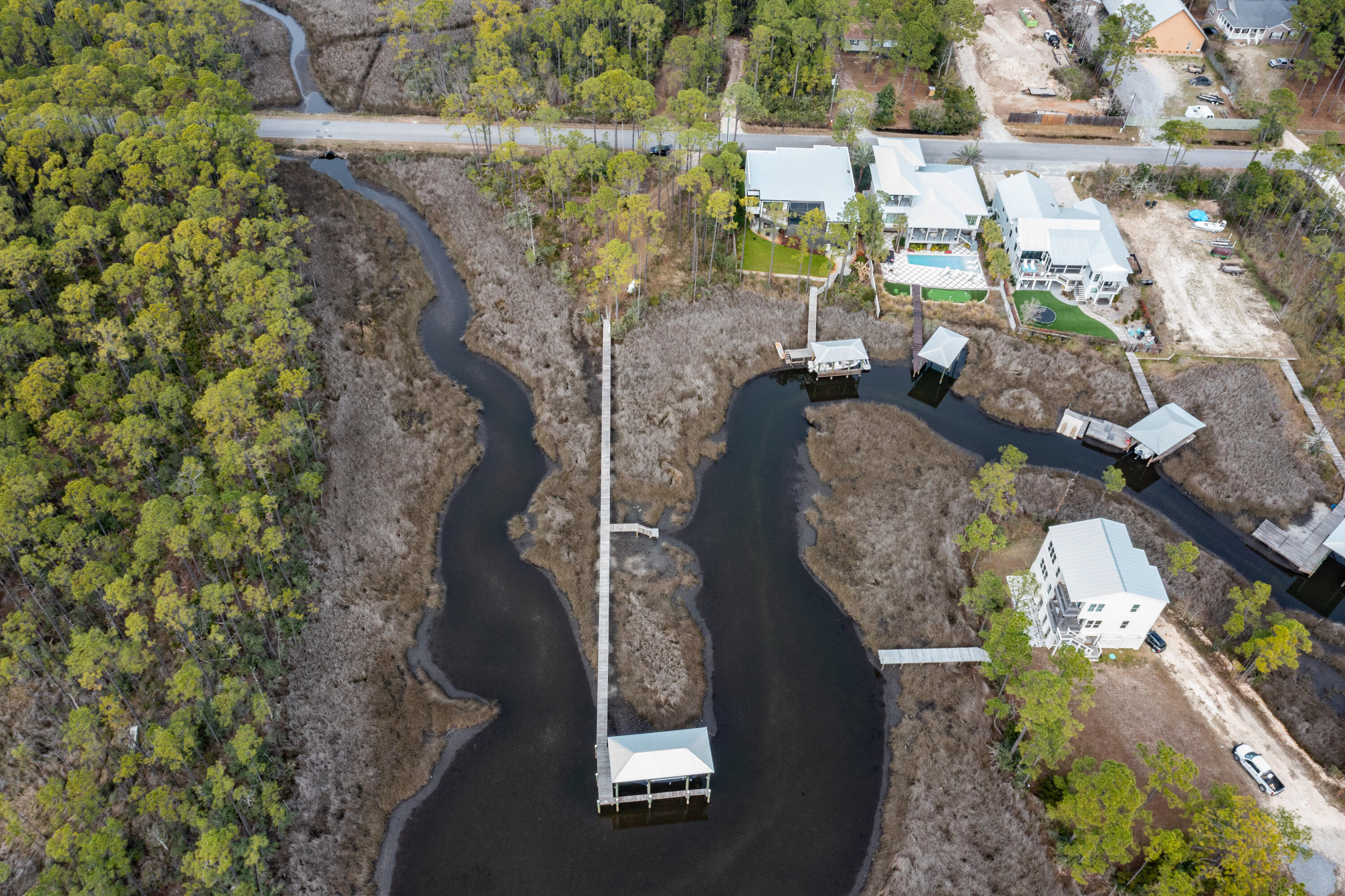 Beautiful waterfront lot, on protected area of Hogtown Bayou.  248 ft dock, covered 20,000 lb capacity Golden lift w/remote, includes water & power, separate kayak/yolo launch.  This lot includes plans for 3500 sq-ft home, permitted and approved by Walton County.  No HOA.  ***Buyer is responsible for personally verifying details about this property.  Any information contained in this listing is believed to be accurate but is not guaranteed.***