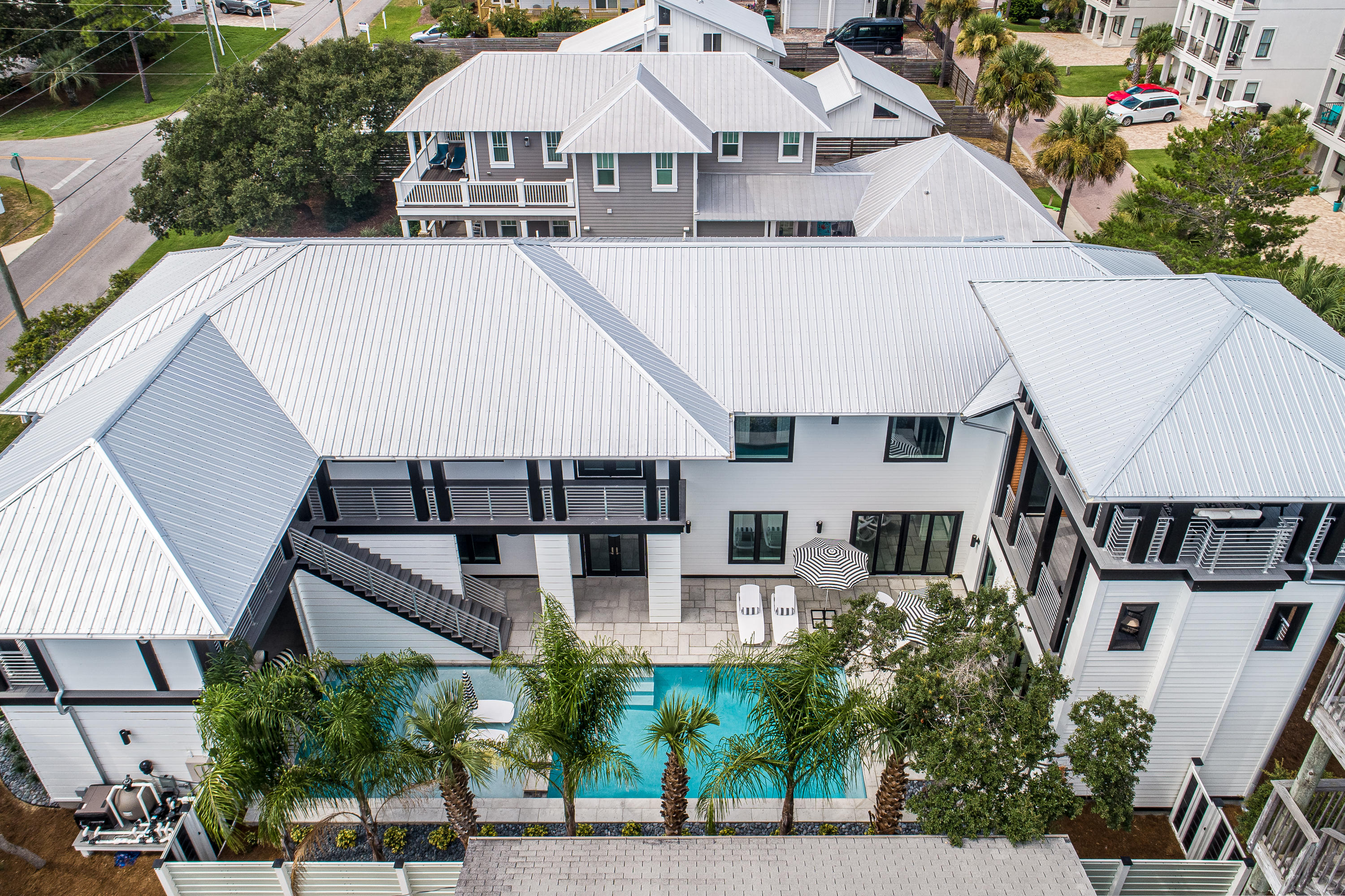 Come Fall in Love with this Amazing home on the WEST side of 30A, where life seems to slow down! This ICONIC home offers gulf views, lake views, a private pool, public beach and private deeded beach access.  With 5100 sqft of Architectual style designed by Tyler Doin and built by Wes Limbach, this house is a true one of a kind!  The uniqueness of this 7 bedroom/6 bath home will leave you in awe!   Kimberly of Tipton-Valentino Designs has brought her Boho Modern Style to 30A with a twist to every room. You will not want to miss seeing this amazing home!  Courtyard entrance greets you with tranquility! Unwind and relax as you see and hear the flow of fountains and bubbles from the amazing pool and spa..  Enter the home and immediately fall in love with the featured art wall and open st Featuring open concept gourmet kitchen with wolf range appliances, 12 ft long custom made dining table by local Luke Langford, floor to ceiling concrete fireplace  room, 2 master suites, 2 bunk rooms, 2 guest rooms each having an on suite, a movie room, 2 laundry rooms, 2 half baths, over size two car garage with heated and cooled owners storage. Multiple porches allow families to spread out and enjoy outdoor living when you aren't at the beach.  A grilling porch with outdoor dining, sleeping porch with a fireplace, upper porch with views of Oyster lake and the Gulf and last but not least a pool with sun shelf, fountains and spa with swim up bar seats to enjoy outdoor tv entertainment!  This home is sold furnished!  The art from artistians Madison Stone, Laurel Galloney, Marisa Silver and Kimberly Tipton-Valentino will also remain with the home.  Looking to invest or just call it home, you will not find another one like this on 30A!  Come let the walls talk and tell you their story!  They all will say Welcome Home!  Home is sold furnished!