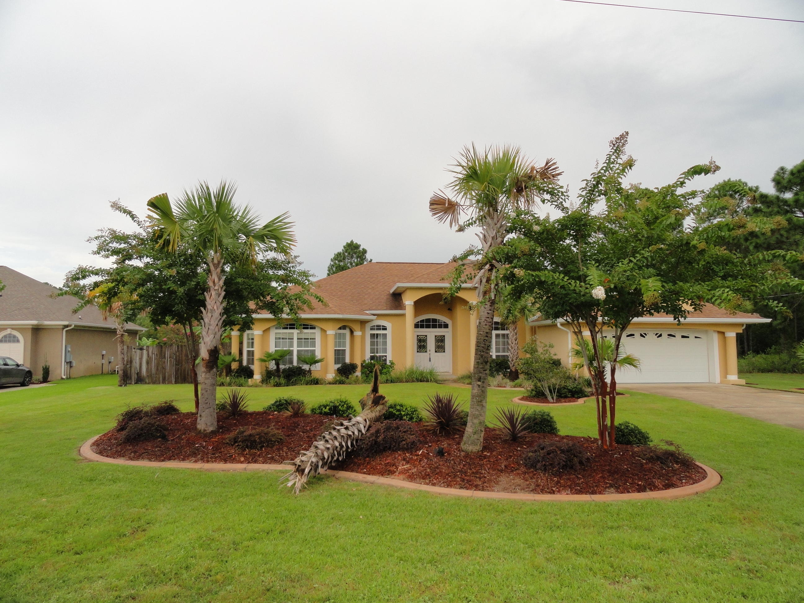 BEAUTIFUL HOME IN NAVARRE! THE IS FOUR BEDROOM HOME IS SITUATED ON NEARLY HALF AN ACRE OF LAND. CONCRETE INSULATED FORM CONSTRUCTION! FEATURING COLUMNS, PALM TRESS, AND BARBECUE PIT, THIS HOME IS THE PERFECT PLACE TO ENTERTAIN. OPEN AND SPACIOUS FLOOR PLAN WITH SPLIT BEDROOM. TILE, HARDWOOD, AND CARPET THROUGHOUT. MASTER BEDROOM FEATURES WALK-IN CLOSET WITH A LARGE GARDEN TUB!THREE ADDITIONAL BEDROOMS AND TWO ADDITIONAL BATHS! LARGE FENCED IN BACKYARD WITH LAWN PUMP AND SPRINKLER SYSTEM! THIS HOME IS READY FOR YOU!