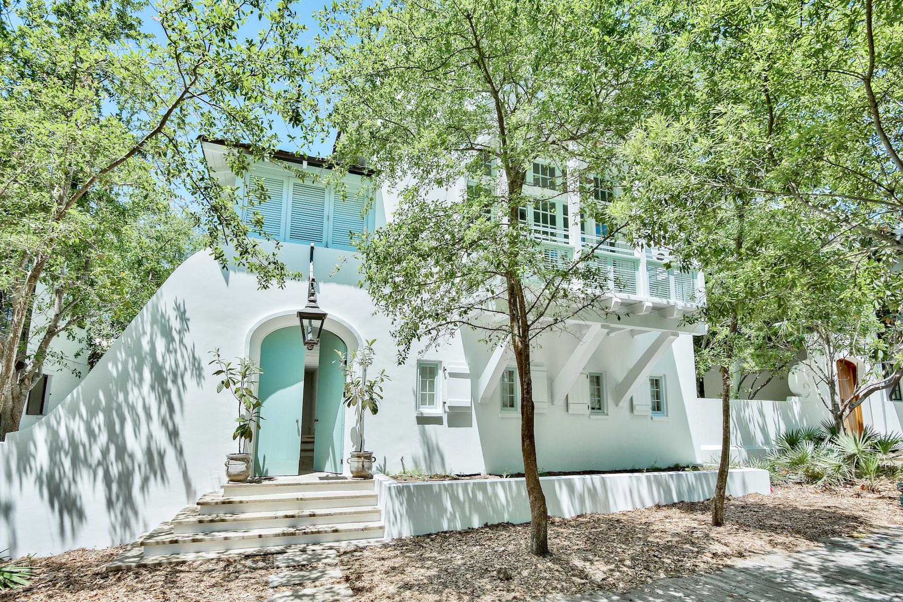 New Exterior of all-white stucco with light blue shutters now complete. Large lot accommodates a pool. This West Indies design by noted architect Ruard Veltman offers a unique architectural style in a fabulous south of 30-A Rosemary Beach location.
Quality abounds in this custom three level, four bedroom, four and one-half baths classic. Features include curved masonry walls, vine draped arbor trellises, cedar shake roof, shuttered porches, copper gutters, and oversized lanterns. Your private courtyard connects with the very scenic boardwalk H and is steps to the beach.
Newly updated interiors feature a bright color palette of whites and pale gray.
Enter to find three bedrooms on the first floor; a beautifully appointed master suite, as well as two guest rooms with private baths. The second level kitchen features a bright white beamed ceiling that creates an intimate old world ambience. Appliances include two Bosch dishwashers, Sub Zero refrigerator, and six burner Thermador range. 
The showcase living room with 18 foot arched ceiling is adorned with a Parisian chandelier and new Sunbrella linen furnishings from Beaux Interiors. Exceptionally large balconies abound from this second floor living area.   
 Ascend to the third floor to find a wonderful open sleeping space and full bathroom. The perfect area for kids to play and watch TV, this floor features two built-in bunks with two hidden trundles. 
The grounds offer several outdoor seating areas to lounge or to grill. 
With close proximity to the Barbados Pool, Main Street shops, and the beach, 46 Spanish Town Lane offers an attractive reason to own this distinctive Rosemary Beach retreat!