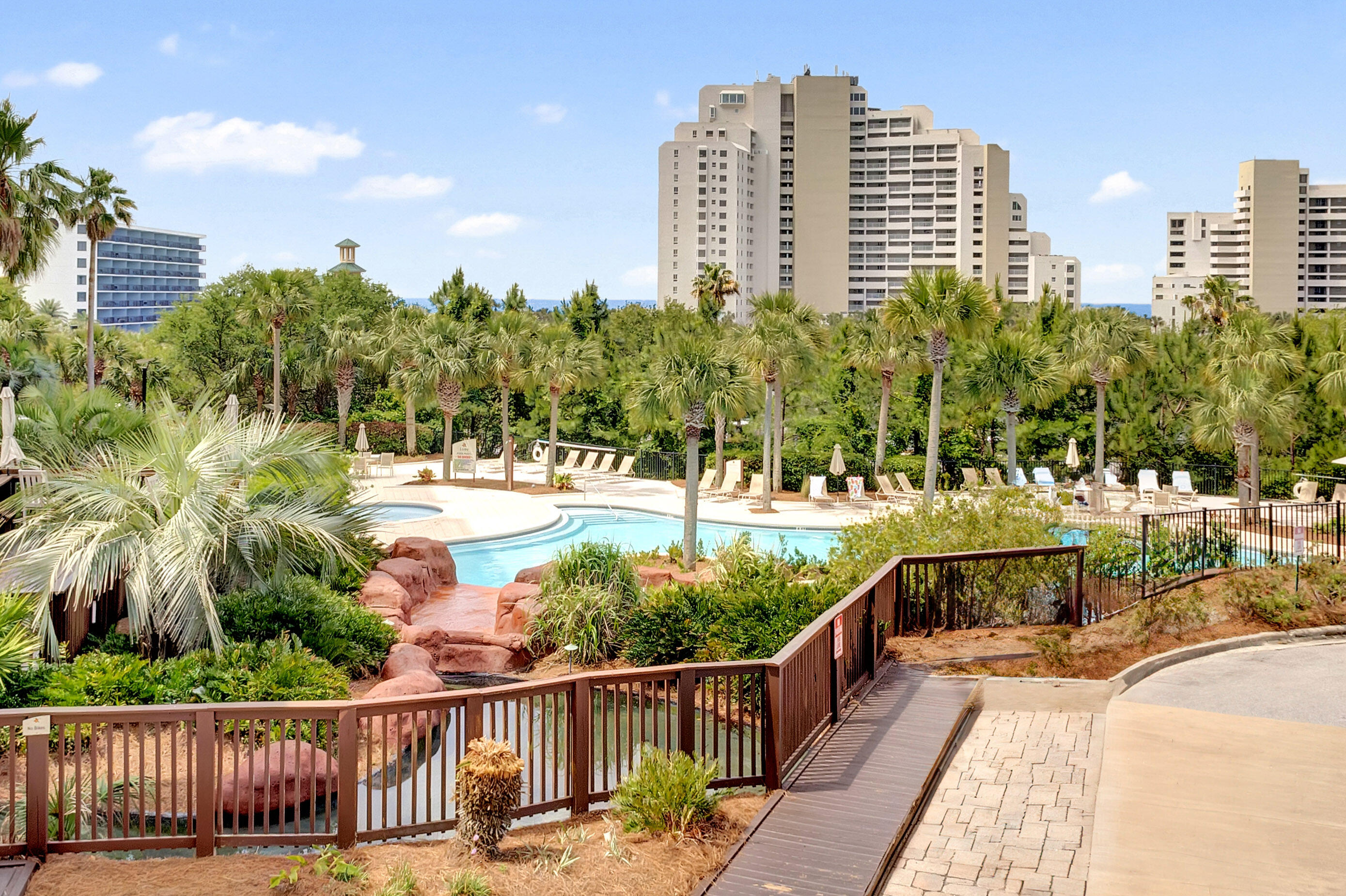 Nestled on the 2nd floor of Luau I, this exceptional corner residence boasts a spacious 388 sqft covered balcony, commanding breathtaking views of the tropical pool area and a tantalizing glimpse of the gulf beyond. Throughout the entire condo, elegant tile flooring creates a seamless and stylish ambiance. Notably, the residence is equipped with a 2014 hot water heater and thoughtful handicapped accessible features, including convenient roll-under sinks and sturdy handle bars, ensuring both comfort and accessibility for all. Luau offers an oasis getaway with a heated pool, relaxing waterfall, hot tub, and grilling area. In addition, owners can take advantage of the sundeck on the top floor with panoramic views from the gulf to the bay or burn some calories in the fitness center.