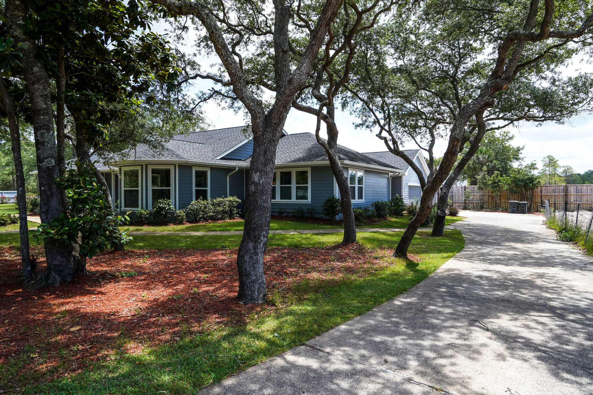 Ever dream of having your own private 'Enclave'? This absolutely beautiful, large private setting with a gorgeous home completely remodeled in 2019 has an Open Concept design & extremely comfortable Coastal Casual feel. The property is situated on 1 acre made up of to ½ acre parcels, adorned w/37 Spanish Oak trees, over 700 Linear feet of fencing w/electronic entry gate, and a NE corner driveway gate that accesses the wrap around driveway. Numerous upgrades must be seen to be fully appreciated, as the materials and craftmanship are both superior. Beautiful Brazilian Plank Tile has been laid completely throughout the home, with the living area walls being made of shiplap. The backsplash tile selection in the kitchen, and the tile for the bathroom shower and tub walls is a perfect compliment to the colors throughout the home. The Marble Countertops add to the quality that exists throughout. Top Quality Bosch Appliances are in the kitchen complimented with a Chef's gas stove. Other upgrades include: A Rannai tankless water heater, a Sunbrella for outdoor patio sun coverage, a 12 x 16 yard shed with A/C and insulation to name a few. In addition, the Hot Tub with pad and surround valued at $14,000 will be included in the sale. The property is in a highly desirable location being less than ½ mile from Sacred Heart Hospital and within three minutes of Grand Blvd, with an outstanding array of shopping, dining, and entertainment venues. The Beaches of South Walton can be accessed easily. Come see the property and make it yours forever!