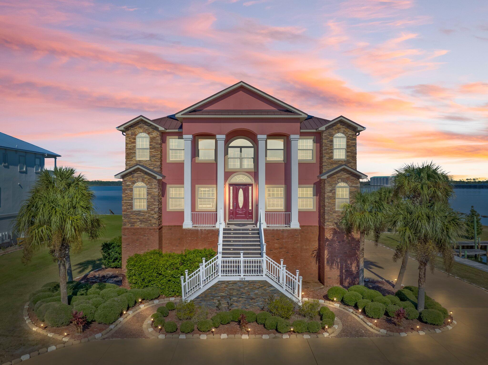 Luxury at its finest! This magnificent 3 level home with stunning exposure to North Bay (190 ft) delivers all the sumptuousness your heart desires. It is a boater's dream property, not only because of the Bay but a deep access canal with approximately 85 ft of dock (slip 11.5 x 21). All waterfront exposure has extraordinary seawall protection. Who says you can't have everything? Aside from the awesome waterfront exposure you have tremendous open yard space, the access entry to the home is quiet and tucked away, circular concrete drive and plenty of extra driveway parking for extracurricular vehicles (RV's, boats).The garage is oversized three car + and elevator access is immediately available from the interior garage entry and services all 3 floors. The gunnite pool is built up three feet on a spacious patio that merges onto the covered porch area (21.5x37.5) with access to the first floor rooms and a full bath. The ground level is all about recreation with kitchenette, several spaces for game room, exercise room, office, or whatever your heart desires, plus a 6th bedroom, full bathroom with a door to the pool area, 2 climate controlled storage rooms and access to the large pool and patio overlooking the huge yard. The impressive main entrance (2nd floor) has soaring 20 foot plus ceilings making the foyer strikingly elegant! The conspicuous porcelain, marble like floors captivate the attention, arresting the flair for coastal elegance. On this 2nd level are the huge living room, custom gourmet kitchen, formal dining room, and informal dining area with fantastic water views from the many windows and French doors which lead out to the spacious balcony (20x18). The main bedroom is also on this floor with balcony access. The luxurious master suite is equipped with a huge sitting room with Bay views, separate bedroom, balcony, massive closet/dressing room, soaker tub, double walk-in shower. The custom gourmet kitchen features a huge butler's pantry, oversized Kitchen Aid stainless fridge, all stainless appliances, insta-hot water spigot over the stove. You will see the luxurious interior appointments of this fine home to include both porcelain and hardwood floors, granite countertops, custom cherry cabinetry, beautiful & detailed double and triple layered crown molding, chair rails, recessed lighting, archways and bull nose corners. The 4 spacious bedrooms on the 3rd floor have Jack and Jill bathrooms. The 3rd floor also has a grand room with access to the large patio that can be a second family room, game room, media room, etc. This gorgeous home has so much more than even described here! Call for a private tour. According to the City of Lynn Haven and Building Department vacation rentals are allowable.