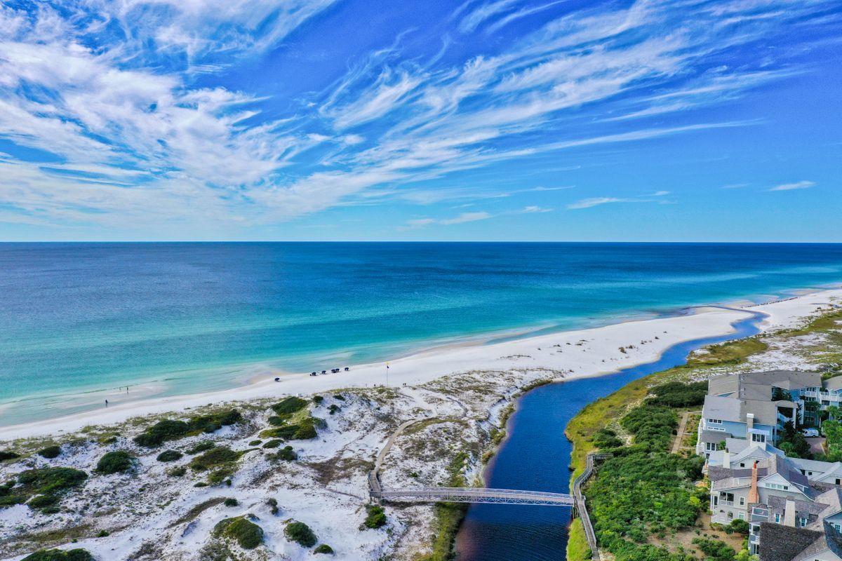 Fully renovated first row Gulf-facing home in Watersound offers stunning views of the Gulf. Completion January 2021. Towering sand dunes and Camp Creek offer privacy that truly transcends everyday life. Listen to the Gulf waves from the glamorous outdoor bathtub, or relax with family on one of the deep-sized private balconies. Direct beach access is just opposite the outdoor shower. Carefully selected finishes that adorn the bath areas include Akdo Tile in Calcutta Gold and limestone, white carrera mosaic marble and Thassos marble. Cabinetry is crafted by Markus Dannecker, a 5th generation Swiss Cabinet Maker. The kitchen island is of bleached walnut. Bath works by Hansgrohe and Lacava. Other notable features include reclaimed wood flooring, visual comfort lighting, Control4 system ad motorized TV lifts. Two new Nano Door systems open to a pillar-less view of the enlarged pool and stone deck. The brand new tower captures coastline views for miles east and west. The main house features five bedrooms, four full baths, one half bath and two laundry areas. The carriage offers a full kitchen and full bath. The three-bay garage comes with additional drive way parking. An aesthetically pleasing community pool, lounge deck and kitchen is just a few doors away. One of the closest homes to the beach in Watersound and located in gated Watersound Bridges.