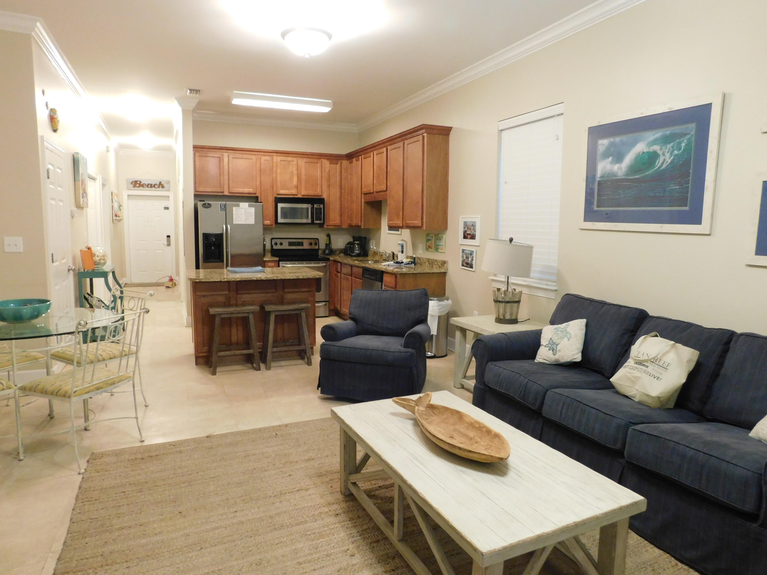 CORNER UNIT, First Floor Condo with screened back porch opening to back yard of sand and trees, very accessible for pets. Seagrove Highlands is a two building gated community, located just off 30A down Somerset Road in a quiet location. This three bedroom, two bath fully furnished and rental ready unit has travertine flooring with carpet in bedrooms, stainless steel appliances, covered entrance to front door and separate owners closet outside unit. The floor above this unit has soundproof membrane flooring for noise reduction. Open floor plan with view of forest. Nice amenities include pool, grills, fishing pier, clubhouse, Golf Cart charging station, attractive landscaping and lots of parking. Beach access is only a few blocks directly across from Tom Thumb Store.