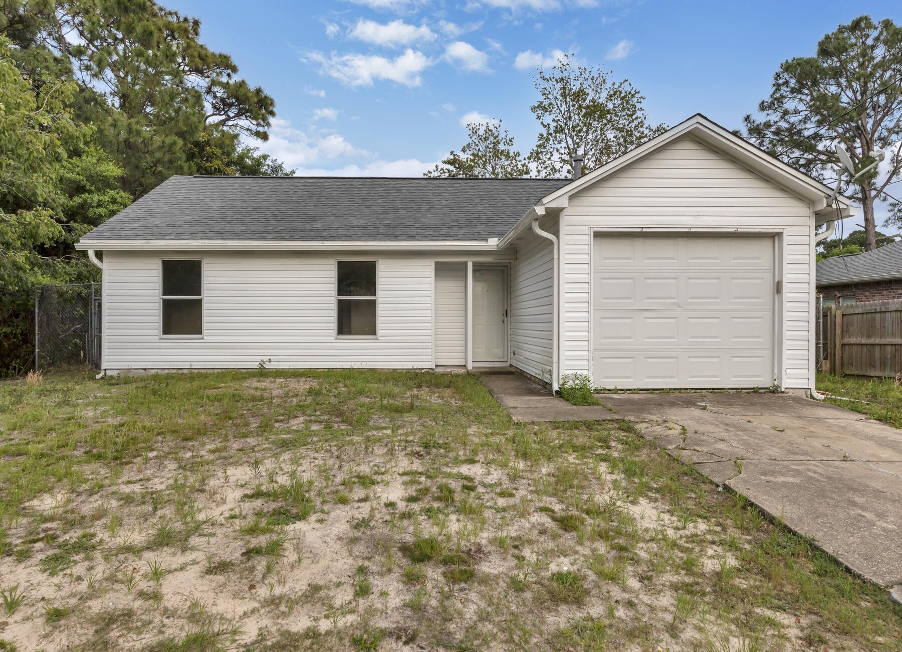 WELCOME HOME!  GARAGE, FENCED BACKYARD, NEW UPDATES.   3 Miles to Hurlburt Field // Eglin Air Force Base; 6 miles to Navarre Beach; 9 miles to Downtown Fort Walton Beach // Okaloosa Island Beach. 
 Close by to Restaurants, Shopping, Beaches, and Recreation.              Recently updated with New Roof, New Siding,  All New Lights & Fans, New Stainless Steel Oven/Range, New Range Hood, New Toilets, and recent paint/carpet.        This home is at the end of Aleta Avenue, and thus offers much privacy.   Fenced backyard is ideal, along with room for a Trailer or Boat to be parked beside the house.   Full bath in hallway; half bathroom in the Master Bedroom.  Washer & Dryer hookups are conveniently located in the Garage.  MEASUREMENTS ARE APPROXIMATE; PETS CONSIDERED ON CASE BY CASE.  CALL TODAY