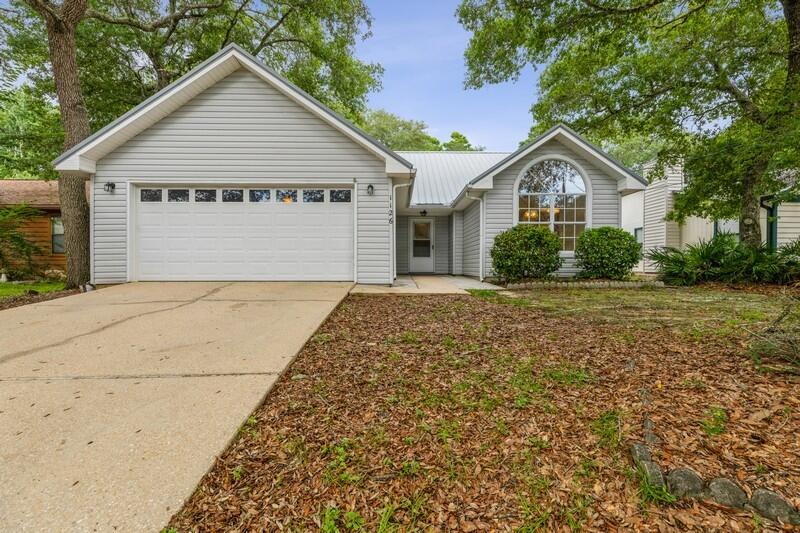 Nestled in the heart of Niceville!  This charming ranch home is convenient to EVERYTHING...Eglin AFB, EOD School, Destin-FWB Airport, shopping, parks, schools, eateries & minutes to sugar-white, sandy beaches!  Sunny, light-filled kitchen features vaulted ceiling, island & enormous window perfect for birding!  Primary bath has double vanities & new shower-surround!  Gas fireplace!  Metal roof!  Shady backyard comes complete with shed/workshop & lemon trees!  Washer/Dryer stay!  Make an appointment today to see this one...there is lots to love!