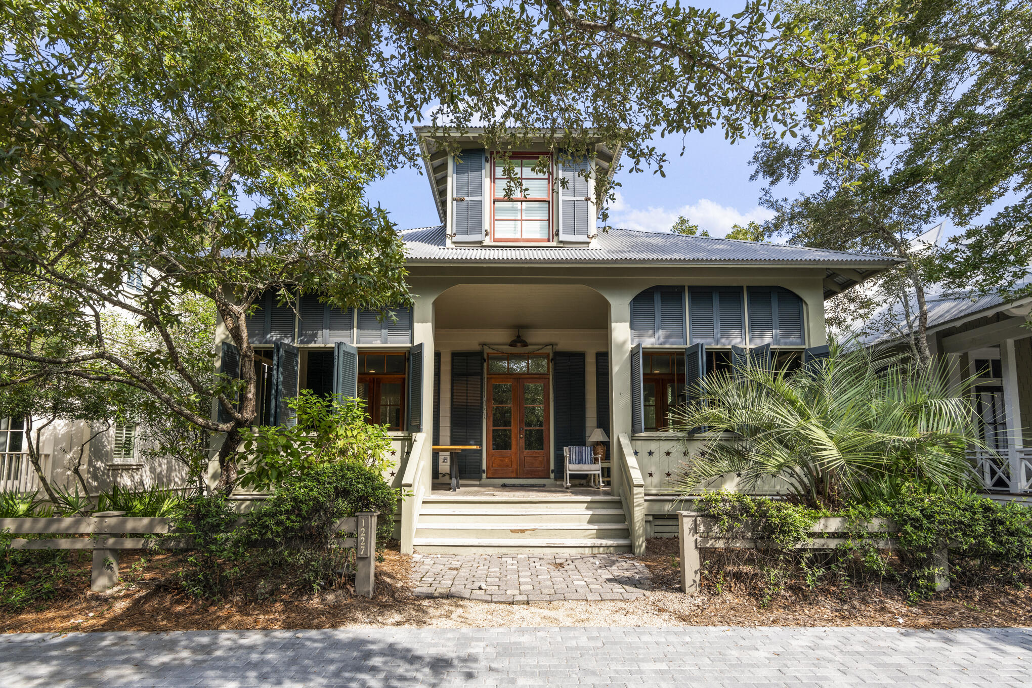 Primely positioned in Watercolor's Camp District, this is coastal living at its finest. The beaches of WaterColor are just a short bicycle ride or walk away, as are so many WaterColor amenities such as the Tennis Center, the Boat House and the spectacular neighborhood pool. This lovely home offers a gourmet kitchen which features stainless steel appliances, a gas stove and wooden butcher block countertops. The kitchen transitions into a beautifully appointed dining room and living room. The fourth bedroom doubles as a second living area, and features a TV/stereo entertainment center. Friends and family can kick back under the ceiling fans on the furnished porch after a day on the beach. Starting on the first floor, the primary suite has a king bed, a TV ensemble and its own bath which features a separate claw-foot tub and shower. The second bedroom has a king bed, a TV entertainment center, and also has its own bath with a shower only. The third bedroom has a double bed and a shower bathroom with a single vanity. The fourth bedroom, which is on the second floor, has two full over full bunk beds and queen sleeper sofa, a shower bathroom with a double vanity. The separate den is a favorite with the kids. An outdoor shower is the perfect place to rinse off after a day at the beach. This home also has an outdoor propane grill and a car port.

SLEEPING ARRANGEMENTS:
FIRST FLOOR:
- Primary Bedroom: King, Private Bathroom with Shower and Tub
- Guest Bedroom: King Bed, Private Bathroom with Shower Only
- Guest Bedroom: Full Bed, Private Bathroom with Shower Only

SECOND FLOOR:
- Guest Bedroom: Two Full over Full Built In Bunk Beds and Sleeper Sofa, Private Bathroom with Shower Only

WATERCOLOR NEIGHBORHOOD HIGHLIGHTS:
- Named the #1 family vacation destination in the U.S.
- A 499-acre coastal resort and residential community
- Ideal bike community perfect for family getaways
- Pristine sugar sand beaches
- 6 swimming pools
- Pickle ball courts
- Award-winning tennis facilities
- Championship golf nearby
- World Famous Beach Club
- Unparalleled beachside, poolside, and lakeside dining
- Acres of parks, gardens, and footpaths
- Nearby state parks and preserves
