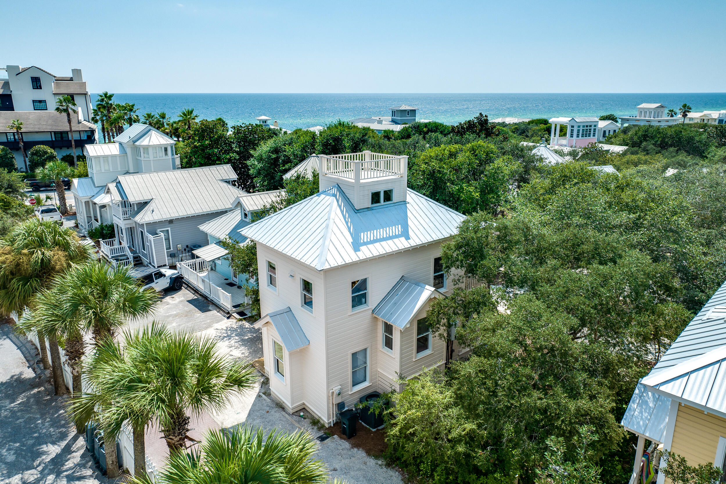 Tucked along Seaside's cherished Rosewalk and just steps from the town center, 54 Robert's Way is a masterfully redefined residence that blends architectural history with modern refinement. Originally constructed as one of the very first spec homes to introduce the Seaside vision, this property has been fully reimagined through a comprehensive renovation completed in 2023. Every detail of the home has been curated with intentionprofessionally designed with a clean, coastal-modern aesthetic that feels both timeless and elevated. The main level offers a private owner's suite with a newly constructed full bath, along with a spacious bunk room and additional full bathroom.

Upstairs, a soaring second floor delivers volume and natural light, housing a brand-new designer kitchen, wet room-style bath, dining area, and an airy living space that opens to a treetop balcony overlooking the lush Rosewalk green space. The third-floor loft, complete with a twin trundle and peek-a-boo Gulf view, adds versatility and charm.

New systems throughoutincluding all new appliances and HVACensure effortless living. Moments from Seaside's iconic town square, world-class dining, boutique shopping, and the sugar-white sands of 30A, 54 Robert's Way offers a rare opportunity to own a piece of the community's legacycompletely redefined for modern coastal living.