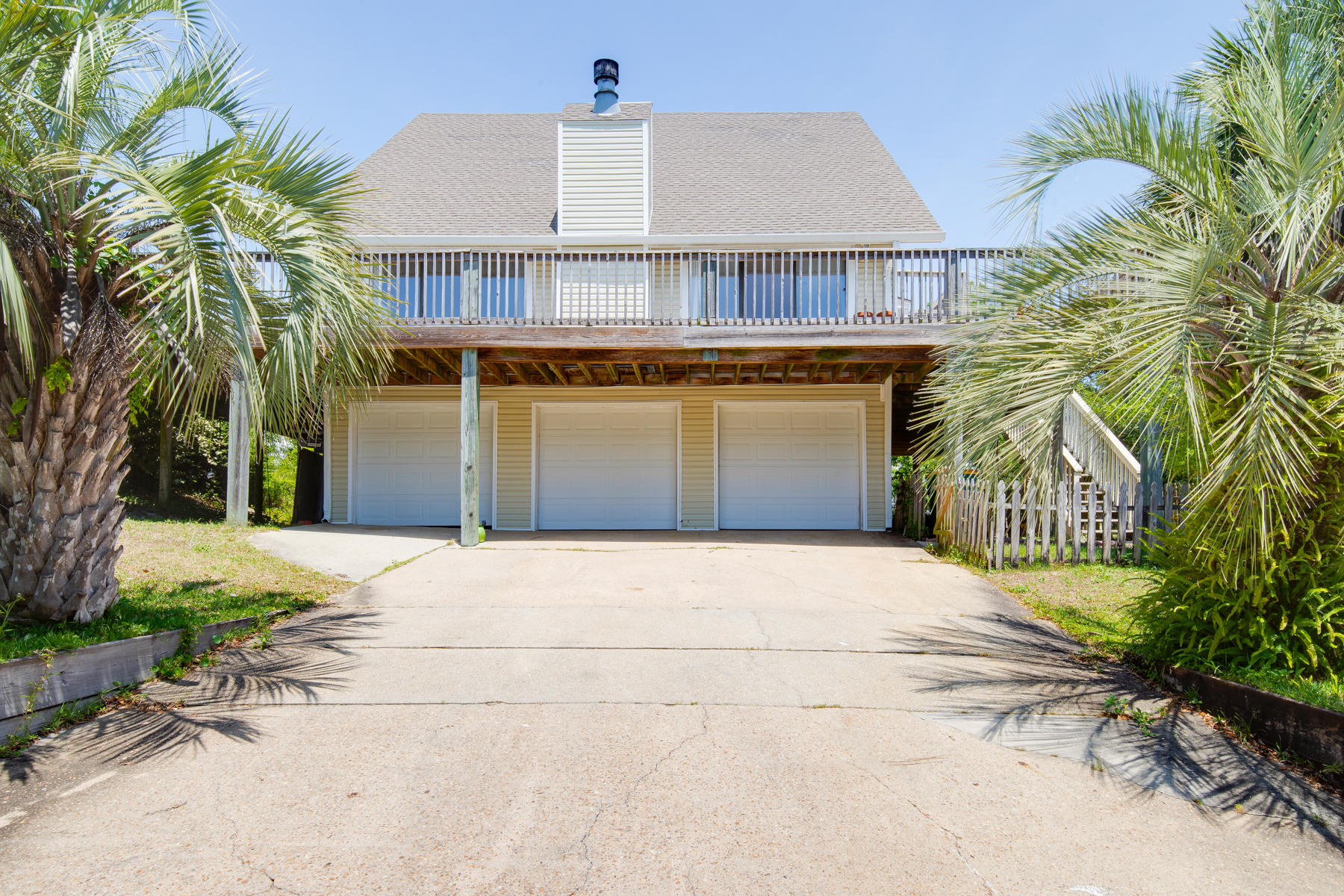 Location! Location! Location! With 3 bedrooms, 2 full baths, 3 levels and a 3 car garage + a large flex area, a vast wrap-around deck/balcony on the 2nd level and private balconies off each upstairs bedroom this home in the Heart of Destin is a rare find! Located at the end of a quiet street, it is only a mile from the Destin Bridge and a quick commute to Eglin and Hurlburt AFB. Numerous options for shopping, dining, and/or nightlife can be found within walking or biking distance. On the 2nd level the living/dining area is open and airy with a cathedral ceiling open to the top level. Two sets of sliding glass doors open onto the huge deck and a cozy fireplace adds warmth to the room. The large kitchen features stainless steel appliances and granite counter tops Beautiful wood floors are found in the dining/living area & the bedroom on the main level and 18-inch tile covers wet areas including a separate laundry room with washer and dryer hook-ups. 

The home features 3 total bedrooms. The two on the top (3rd level) feature wall-to-wall carpet and each bedroom has a private deck/balcony. The bedroom to the right features private access to the bathroom on this level which features a huge garden tub, custom tile work and a rainfall shower head. The bedroom on the main level has gorgeous wood flooring and also features private access to the bathroom on that level which also opens into the kitchen/living area. This amazing home is in a great location with no HOA fees! Absolutely perfect for a first home or an investment property!