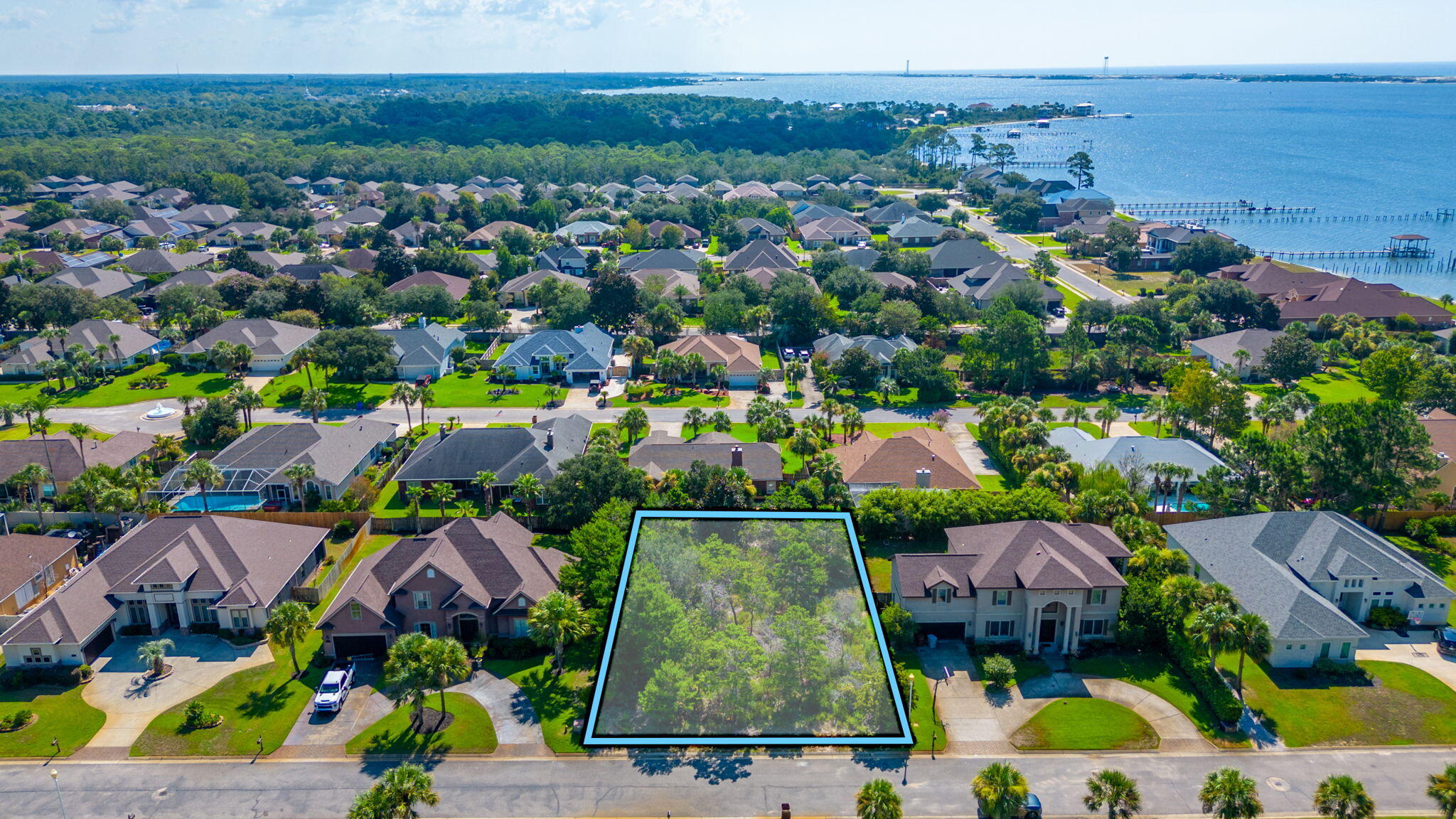 Come build your dream home on this wooded lot in the gated community of La Fontaine, where location is EVERYTHING. Fontainebleau Court is minutes away from ''Florida's Best Kept Secret'', Navarre Beach; 22 miles from the Destin and 27 miles from Pensacola. Lot is walking distance from your own slice of paradise where the community of La Fontaine holds deeded access to the Santa Rosa Sound- Launch your kayak, paddle board, or maybe catch sight of a pod of dolphins while relaxing at the community gazebo.    
Two separate lots For Sale.  See Lot 1 Fontainebleau Court for details on second lot.