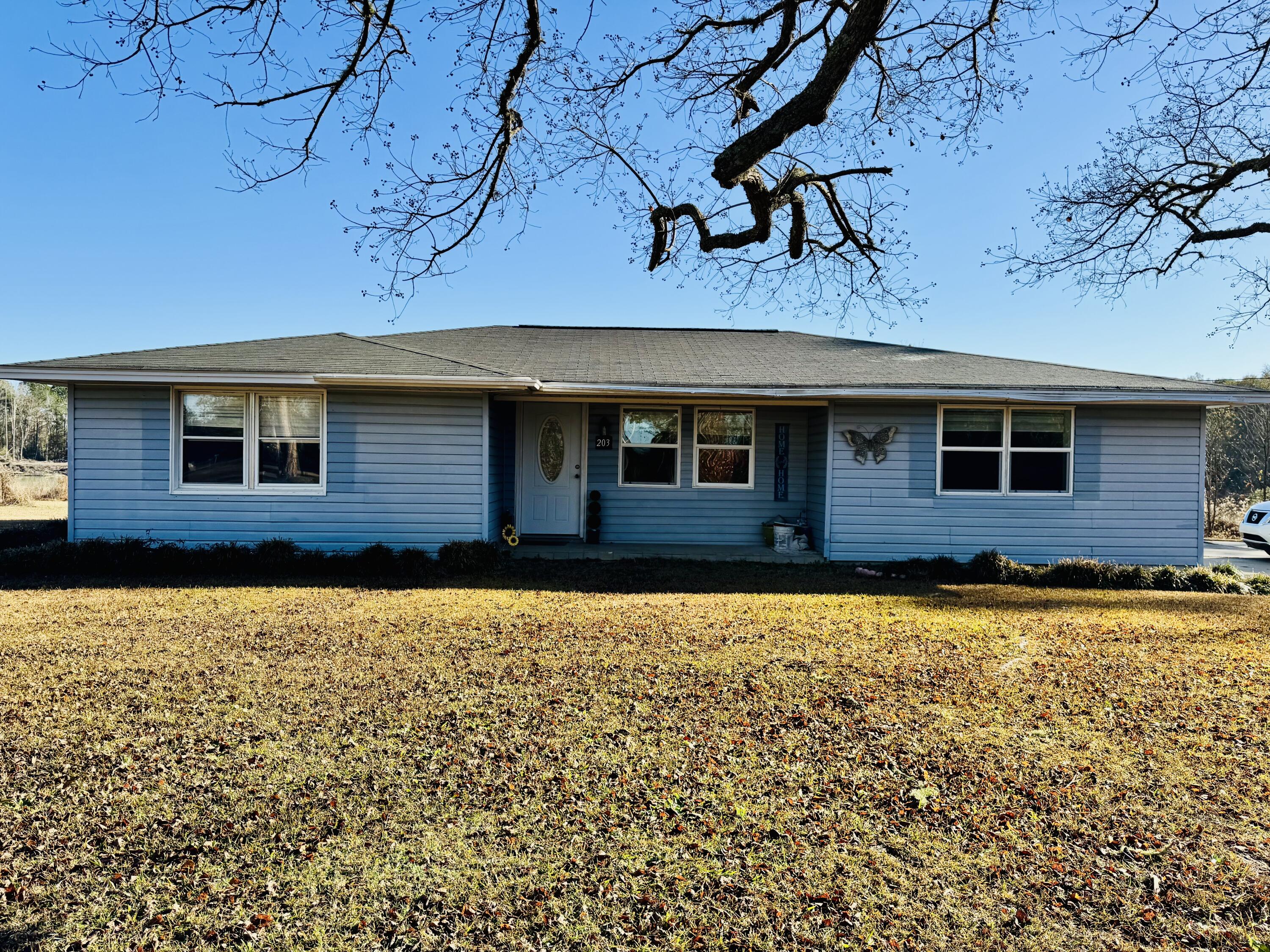 Fixer-upper on a half-acre lot with a generous outbuilding. This home offers a canvas for your vision. The 2-bedroom, 2-bath residence features a mix of tile and carpet, a tile-surround shower, and an enclosed back porch that fills with natural light. The property has been partially remodeled and is being sold as-is, with no appliances included. A standout feature is the 31 X 28 shop/barn with both an upstairs and downstairs space. Perfect for storage, a workshop, or future expansion. With plenty of outdoor space and flexible potential, this home is ideal for buyers and investors looking to customize and tailor the property to their needs.