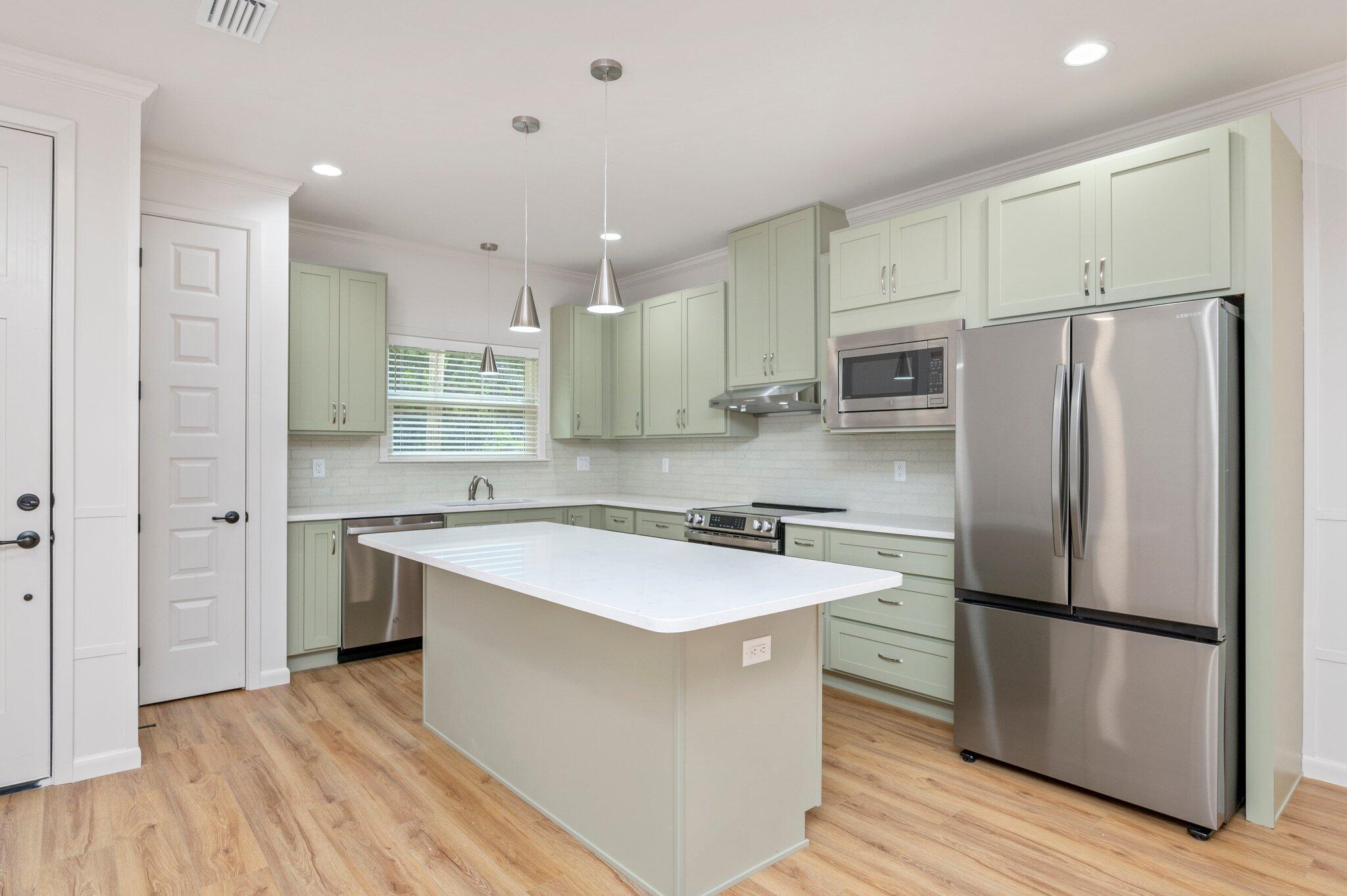 This modern property features 2 bedrooms and 2 bathrooms, perfect for those seeking a comfortable and convenient living space. The interior boasts brand new LVP flooring throughout, high ceilings, and modern fixtures, giving the home a fresh and stylish look. Say goodbye to yard work, as yard care is included with this townhome, allowing you to enjoy the outdoors without the hassle of maintenance. Further enjoyment and privacy can be found in the backyard with an 8 foot privacy fence surrounding. Don't miss out on the opportunity to make this fully updated townhome your new home sweet home.