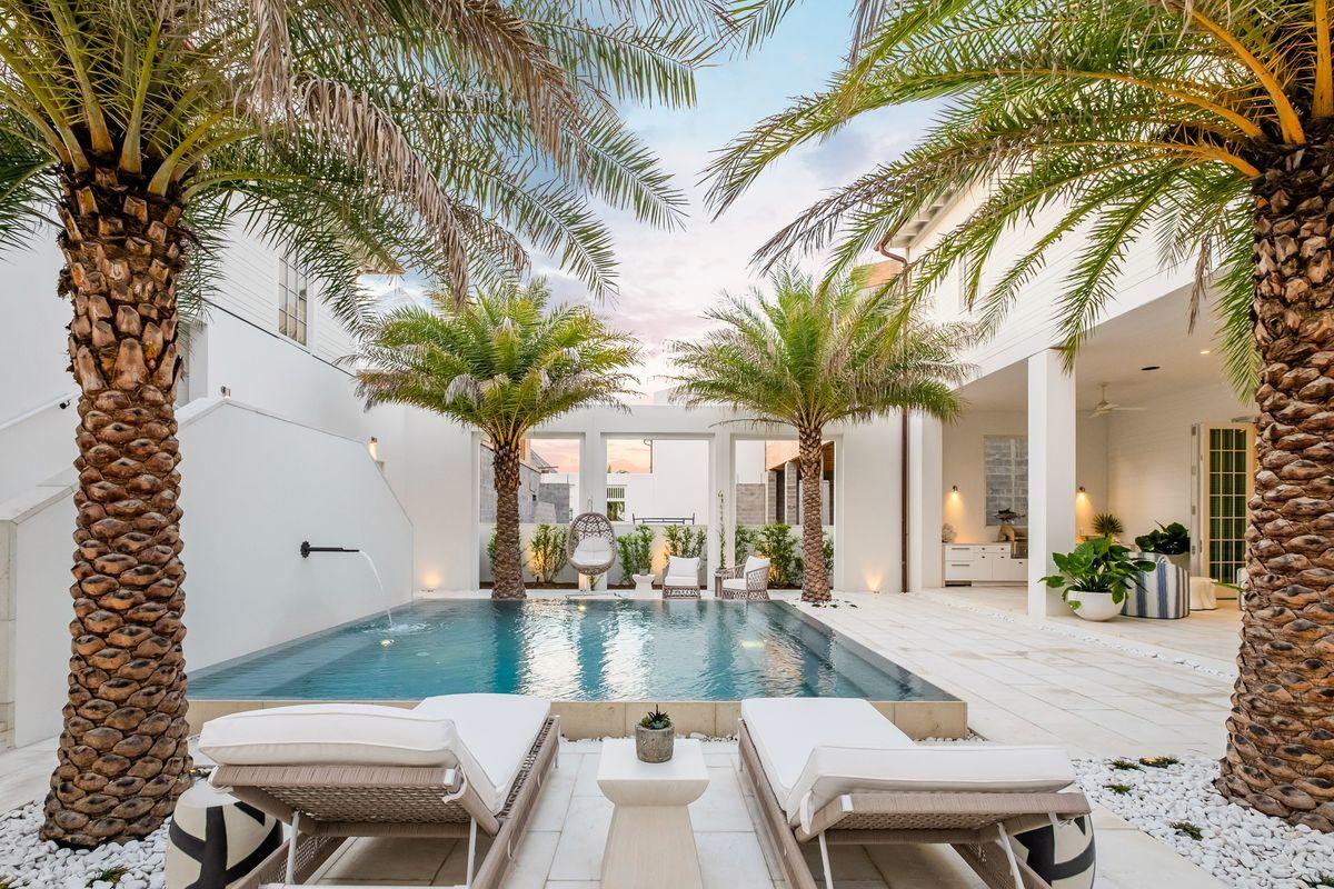 Pristine architectural elements combined with striking interior design by Marisol Gullo characterize this exceptional compound retreat in the exclusive Kaiya Beach Resort. This  lifestyle community created by Romair Construction and Khoury-Vogt Architects is centered around wellness & harmony with the exquisite naturalistic surroundings including a private beach house and Kaiya Club, which are just a few of the forthcoming amenities being developed in this full service resort. 115 Kaiya Ave is a 5 bedroom, 5.5 bathroom courtyard centered home, beautifully decorated and ready for immediate occupancy. The tranquil courtyard and lush landscaped privacy are the perfect anchor between the main house and adjoining guest house with an open layout ideal for entertaining. Yielding over 4,800 heated and cooled sqft, this property offers an abundance of space with ample parking in addition to an oversized two car garage. Lush manicured grounds and oversized porches provide a welcome sense of arrival as a key characteristic to Kaiya's identity, focused on community and family. The open floorplan offers main level living with notable features including peacock paver flooring throughout, finely appointed finishes such as caesarstone countertops in the kitchen as well as Wolf and SubZero appliances accentuated by white venetian plaster walls and a euro style nanawall leading directly to the resort style courtyard & heated pool. The primary living room is spacious and comfortable with a masonry gas fireplace and beautiful coastal decor. There is a separate dining alcove and music room also located on the first level. The chef's kitchen offers a beautiful center island with ample storage as well as a back kitchen for food prep, custom wine storage and a built-in Wold coffee maker. The master suite is located on the second level of the main house and is beautifully accented by a sprawling covered porch that runs the full length of the home complete with ipe decking as well as a spa-like ensuite master bathroom offering dual vanities, gorgeous marble tiling, soaking tub and walk-in shower. There are three additional bedrooms in the main house including a third floor bunk room, each offering access to a well-appointed ensuite bathroom and central laundry room. The private courtyard is a private oasis with exceptional coastal hues from the private resort pool and ample room around the generously proportioned sun deck. There is a full outdoor kitchen with gas grill, covered lanai and dining al fresco. The adjacent carriage house is a full respite in and of itself, complete with a private bedroom, full bath, office space / bunk room, it is the perfect area to house guests for overflow. Kaiya Beach Resort is complete with a private beach access and is centrally located on the east end of 30A adjacent to Alys Beach and Camp Creek Parkway as well as the world class shopping, dining and entertainment that 30A has to offer.
