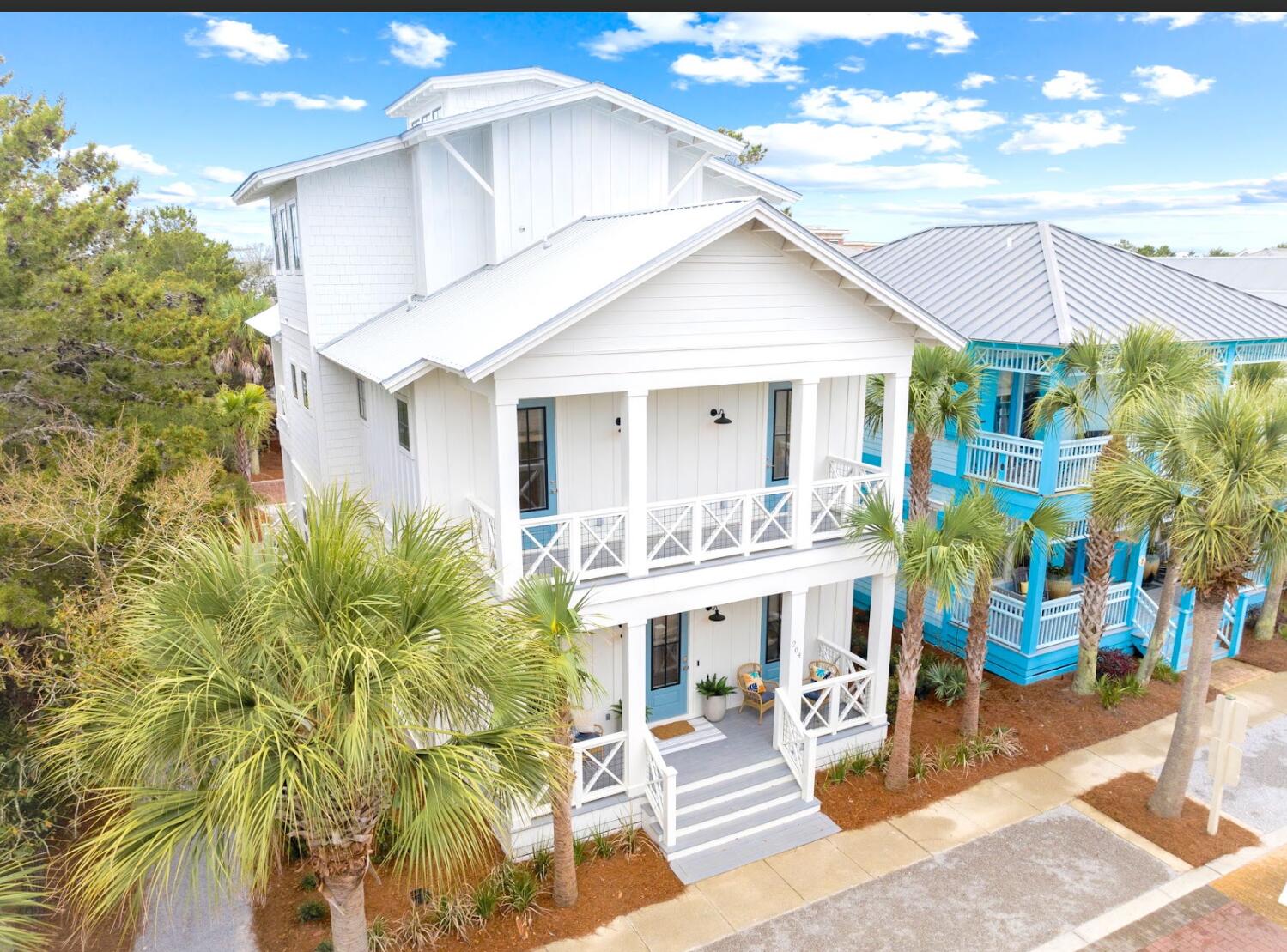 Perfectly positioned between Alys Beach and Rosemary Beach, Seeking Sanctuary was designed for the way families gather, relax, and experience life on 30A. 
Welcome to Seeking Sanctuary, a nearly new 3,300 sq ft home in the heart of Seacrest Beach -- thoughtfully designed to live up to its name. The home offers easy access to dining, shops, and the beach while still enjoying the calm feel of a tucked-away neighborhood between Alys Beach and Rosemary Beach. Inside, a central light tower rises through the home, flooding the interior with natural light from top to bottom and creating an open, uplifting feel throughout the living spaces. Professionally designed interiors combine wide plank floors, shiplap accents, layered lighting, and cohesive finishes that feel relaxed, polished, and timeless. The main living area is built for gathering. A spacious kitchen anchors the home with high-end appliances, a pantry with speed oven, and a dedicated coffee bar, all opening naturally into the dining and living areas. Just outside, the outdoor kitchen and dining space extends the living area and makes it easy to unwind after a day at the beach. Seeking Sanctuary offers 4 bedrooms plus a spacious third-floor loft retreat, along with 4 full baths, a half bath, and a quarter bath. The home comfortably sleeps up to 14, making it ideal for extended families or multiple groups vacationing together.
Two large primary suites feature spa-style bathrooms with freestanding tubs and walk-in showers. Every bedroom enjoys direct access to its own porch or patio, allowing guests to step outside and enjoy the coastal air. One of the most inviting spaces in the home is the second-floor porch, a large outdoor retreat perfect for unwinding after a day on the sand -- whether reading, sharing conversation, or simply enjoying the evening air. The custom quad bunk room creates a memorable space for kids, while the third-floor retreat becomes the ultimate place to sleep or play. With soaring ceilings and a wide-open lounge area, it naturally becomes the home's gathering space for movies, games, and late-night conversations.
Even the practical spaces were thoughtfully designed. The custom laundry room is finished to the same high standard as the rest of the home, making longer stays and full-family trips easier to manage. The home includes three dedicated parking spaces plus two additional overflow spaces, giving guests room to come and go without the usual Seacrest parking challenges. Outside, the location quietly does a lot of the work. A nature trail runs directly along one side of the property, connecting the home to Seacrest's network of green spaces while adding a sense of openness rarely found in the neighborhood. Residents and guests enjoy access to the Seacrest lagoon-style resort pool, nearby parks, and the beach tram. Peddlers Pavilion -- with dining, coffee shops, and live music -- is just a short walk or bike ride away. For buyers looking for a 30A home that balances thoughtful design, generous gathering spaces, and strong rental potential, Seeking Sanctuary brings together location, layout, and livability in a way that is increasingly hard to find. Homes in this part of Seacrest that combine newer construction, generous gathering spaces, strong sleeping capacity, and this level of walkable access between Alys Beach and Rosemary Beach are becoming increasingly difficult to find. The best way to understand Seeking Sanctuary is to experience it in person!