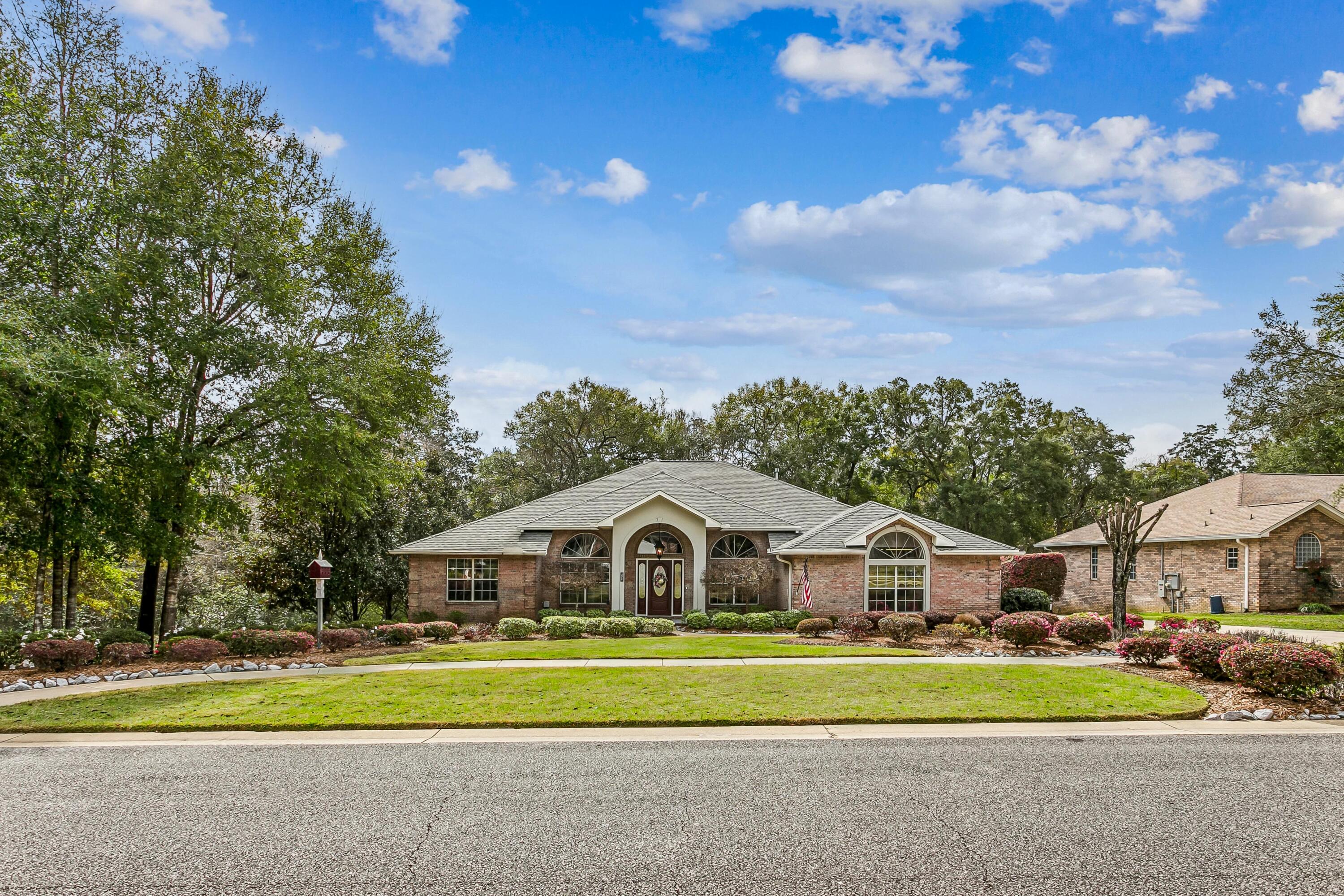 Welcome to this beautifully maintained 4 bedroom, 3 bath brick home in the highly sought after Rocky Bayou Country Club Estates. Built by respected local builder Mike Parish, this property blends timeless craftsmanship with thoughtful modern updates throughout.
Set on a private .43 acre lot backing to wooded land with a retention area on one side, the home offers exceptional privacy and serene natural views. Inside, the main living spaces feature gleaming hardwood floors, while all bedrooms enjoy new carpet. One of the bedrooms is currently designed as a mancave complete with a built-in bar, offering a fun and functional retreat that can easily convert back to a traditional bedroom if desired. A dedicated home office provides the perfect work from home setup.
The kitchen is a chef's delight with a gas cooktop, convection oven, combo microwave/convection oven, warming drawer, and a walk-in pantry. A spacious dining room and an inviting eat-in kitchen offer multiple gathering spaces. The large Florida room extends the living area and overlooks the home's impressive outdoor spaces.
Step outside to multiple levels of maintenance free resin decking with integrated lighting, a gas hookup, and a brick pizza oven - ideal for entertaining. The property also includes a 12' x 24' powered workshop with double doors, perfect for hobbies or storage. Professional landscaping and landscape lighting add to the home's curb appeal.
Practical upgrades include a wireless, whole home security system featuring carbon monoxide sensors and smoke detectors fully integrated into the system, a whole home generator, central vacuum, coated windows, R49 blown-in insulation, floored attic space, and a 3 car garage with a utility sink. With a 2018 roof and 2022 gas water heater, this home has been meticulously cared for and is truly move-in ready.