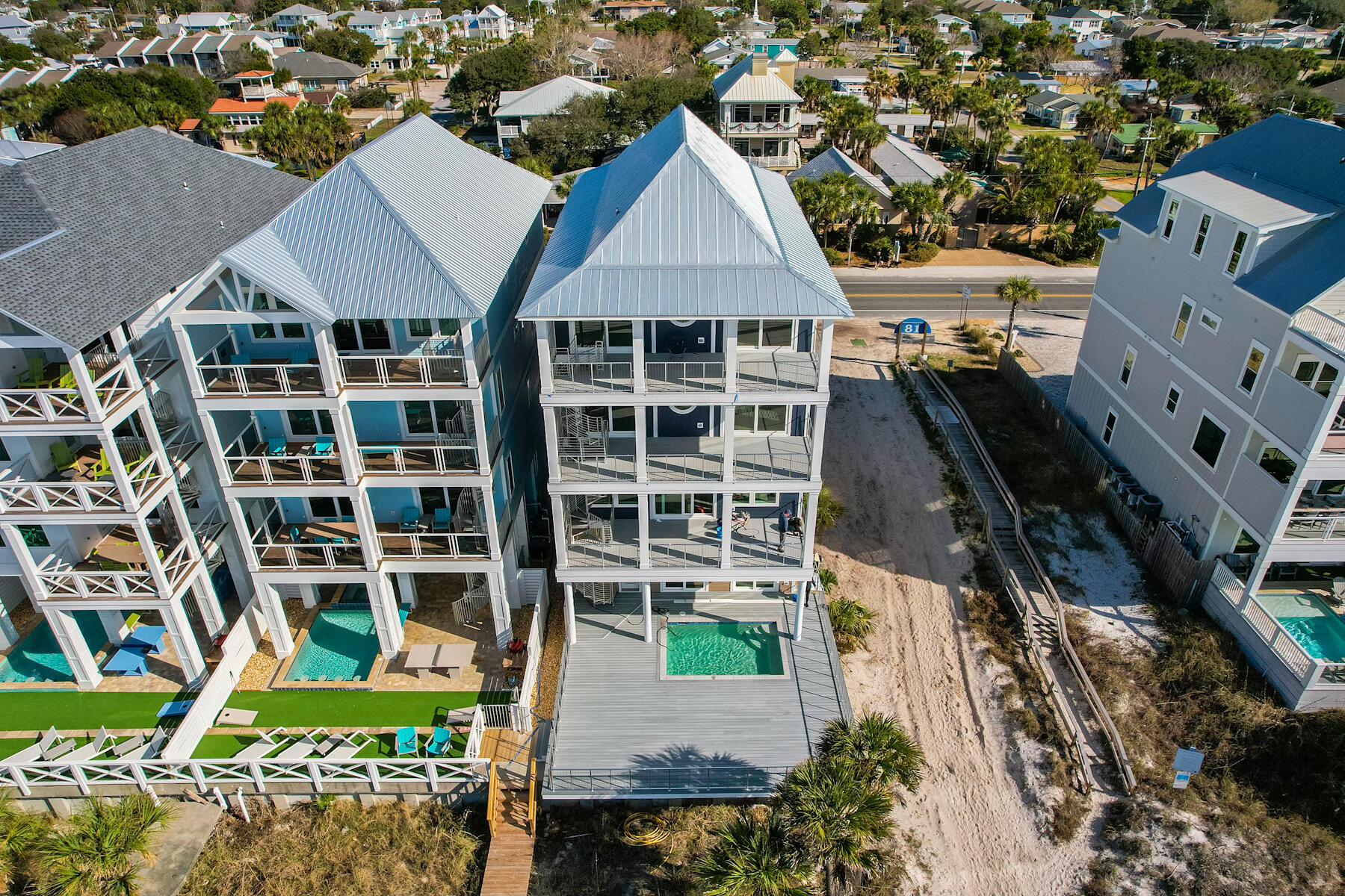 This thoughtfully designed RENTAL MACHINE checks all the boxes! 6589 sq, ft,of interior and covered exterior space to gather and entertain.  As you drive up, ''Don't worry about where to park''. There are 3 covered spaces and 7 additional driveway parking spaces.  This 8 bedroom (each with ensuite bath) masterpiece, boast 4 master suites on the gulf, each with large balconies.  As you enter the bottom level the fun begins in a large arcade/game room facing the gulf.  Walk out and grab a beach breeze and take a dip in the heated saltwater pool or take a quick walk across your boardwalk directly onto the sugar white sand.  A full bath with shower is conveniently located on this level for easy access from the pool.  The spacious second level living/dining/kitchen area presents the perfect area to gather for entertainment or sit together for meals while enjoying the breathtaking views from the full length balcony.  The 2nd through 4th levels offer multiple bedrooms and bunk areas with 4 of the bedrooms being gulf front with large balconies overlooking the water.
As an owner, you will appreciate the little extras in this home that facilitate ease of maintenance and reduction of overhead cost.  Coastal Green Air sensors on all doors and windows, tankless hot water tank, 15 year warranty on siding with color all the way through instead of just painted, and extra support from the well engineered sea wall.  If you are an investor, you will recognize what we mean when we said "This checks all the boxes".  This home was thoughtfully designed with consideration of what guest truly want.....lots of entertainment areas, multiple large spaces to gather, space for all to sit together and enjoy meals, multiple master suites with balconies overlooking the gulf, easy walk out access to the beach and a most important one....plenty of space for everyone to park!   Schedule your appointment to preview today!