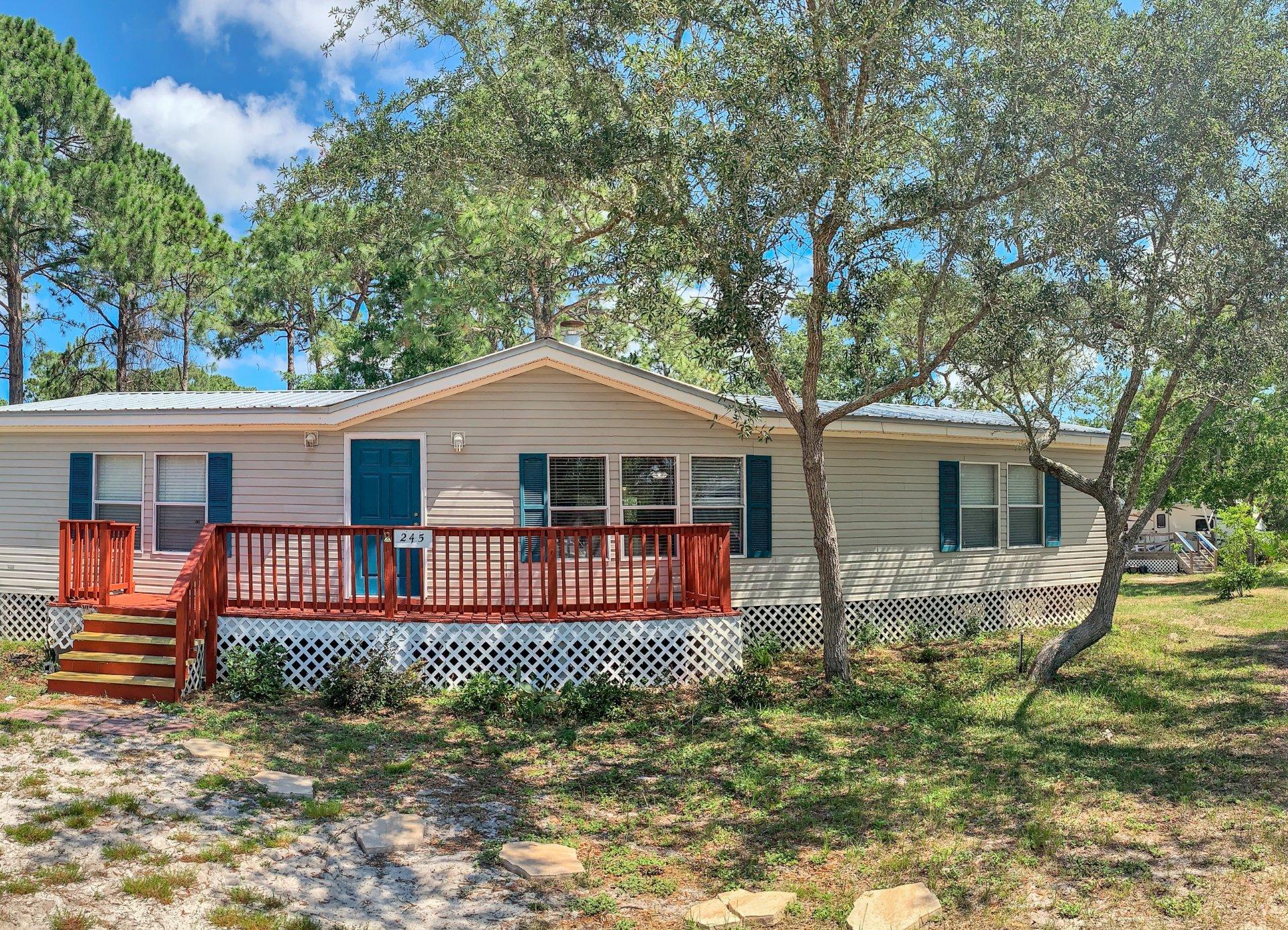 Bay access,Mac Bayou, 1/4 acre land and a well built home. ENJOY the deeded access boat ramp in the community of just a few homes! Property offers room to park your boat, motor home or trailer. This property immediately feels like home. The back deck is nestled under large oak trees creating plenty of shade. Be creative with: room for a pool and beautiful landscaping.This manufactured home has a strong metal roof, and large kitchen, with ample size for a dining table that accommodates the whole family! Home is clean and ready to move into. This rural area, neighbored by well kept homes creates pride, a sense of safety, and walk the dog, let the children play in the yard feel. So close to the hospital and Grand Shops. Ride a bike or take the golf cart! Awesome land and wonderful home!