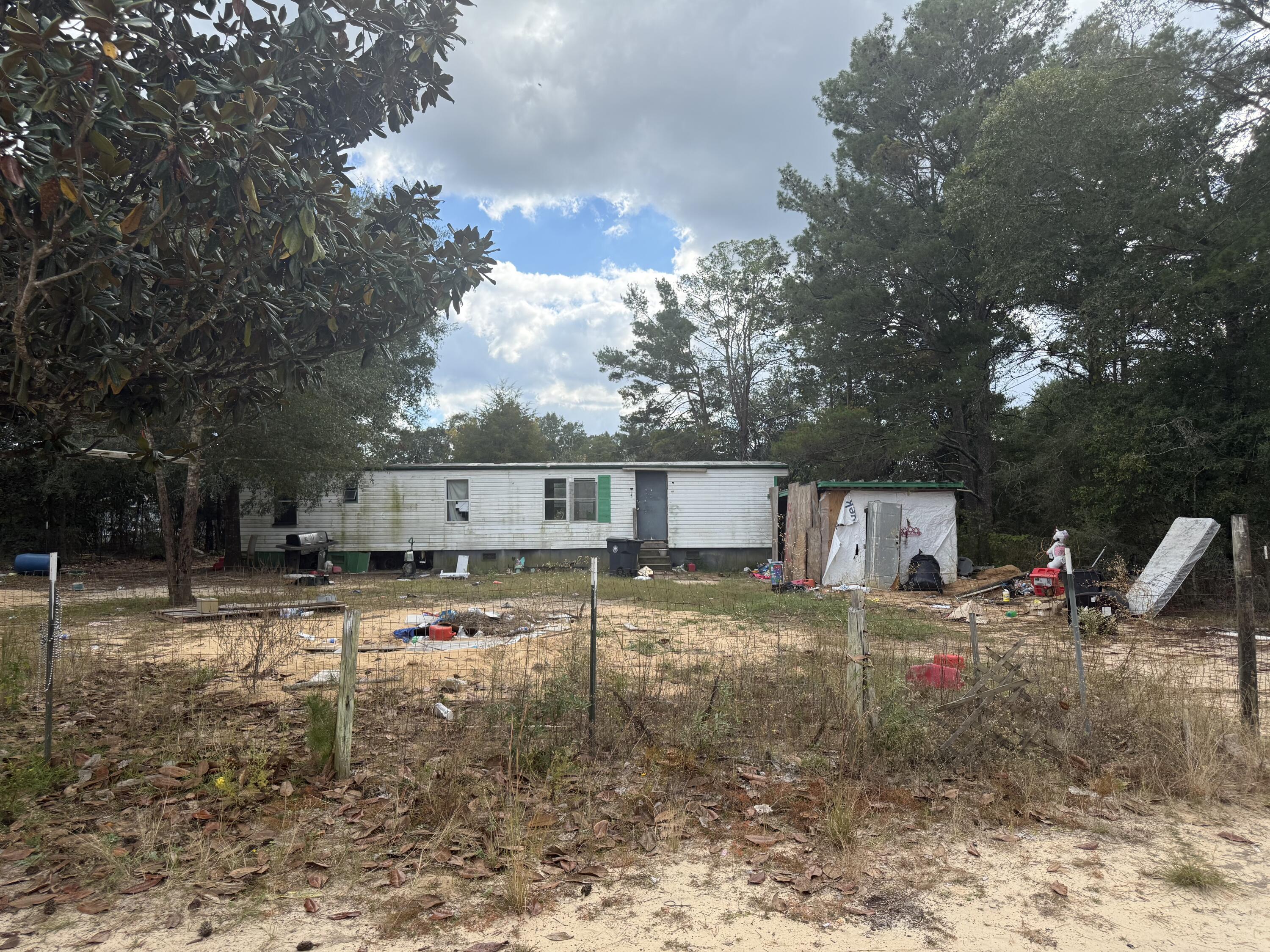 A rare opportunity to secure land with previous utilities.
The land parcel at 61 W Juniper Ave in DeFuniak Springs is a residential property located within established neighborhood, Oakwood Hills, and offers a private setting for future home construction or investment. The current home has little to no value.
The seller will not remove the current home, trash or furnishings. This sale is AS-IS.
Listing agent has resourced lot information from the County Property Appraiser's website.**All information provided via this listing deemed to be reliable but is not guaranteed**. While the listing agent believes that the acquired information is accurate and true, the buyer and/or buyer's agent should verify all details related to this property prior to purchase.