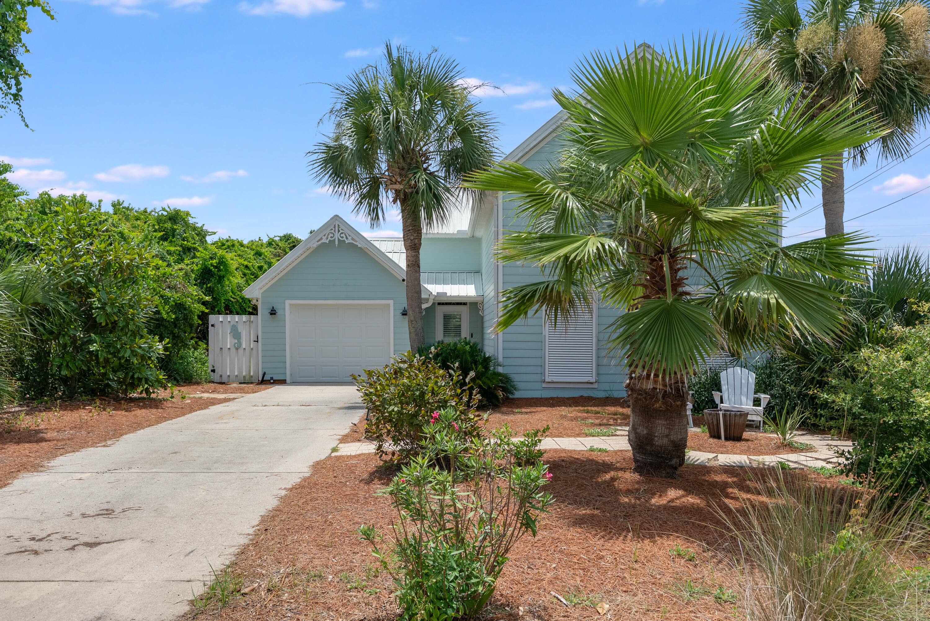 Just 95 steps from the sand, this freshly re-imagined coastal retreat exudes charm, sophistication, and timeless appeal. No detail was overlooked in the recent renovation of this 3-bedroom, 2-bath home, thoughtfully designed with the primary suite conveniently located on the main level. The open-concept living area features a cozy fireplace and flows seamlessly into a beautifully appointed kitchen, complete with new appliances, designer backsplash, and stone countertops. A stylish dining area enhances the layout, ideal for everyday living or hosting guests. Step outside to the true showstopper—a spacious, covered porch that lives like an extension of the home and opens to a private, lushly landscaped backyard oasis. Upstairs, two additional bedrooms, a full bath, and a charming balcony offer the perfect perch for morning coffee or sunset views. Blending coastal elegance with effortless livability, this classic beach cottage is your refined escape by the Gulf.