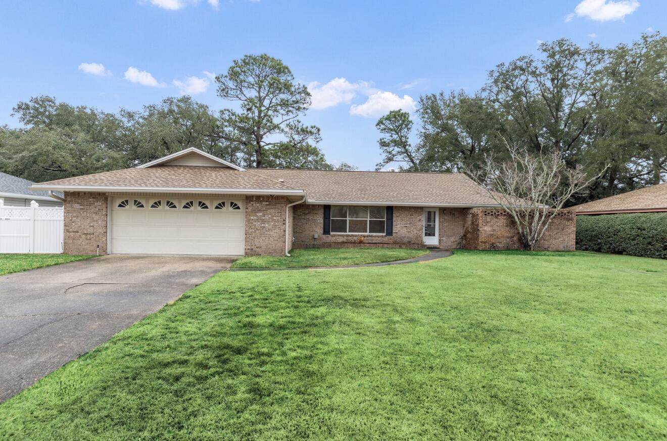 Large home on the Golf Course in Lake Lorraine Estates. This split floor plan has three spacious bedrooms and two bathrooms.  Three living areas allow for limitless entertainment possibilities.  You are greeted by a large formal living area with an open dining room as you enter the home.   A separate family room with a gas fireplace is open to the kitchen.  Finally a large heated and cooled Florida room overlooks the Golf Course.  The primary suite opens out to the lush backyard.  The primary bathroom opens out to a private bricked in zen garden. New roof in 2023.  New tankless water heater in 2022.  Close to Eglin and Hurlburt AFB, shopping and beautiful sand beaches.