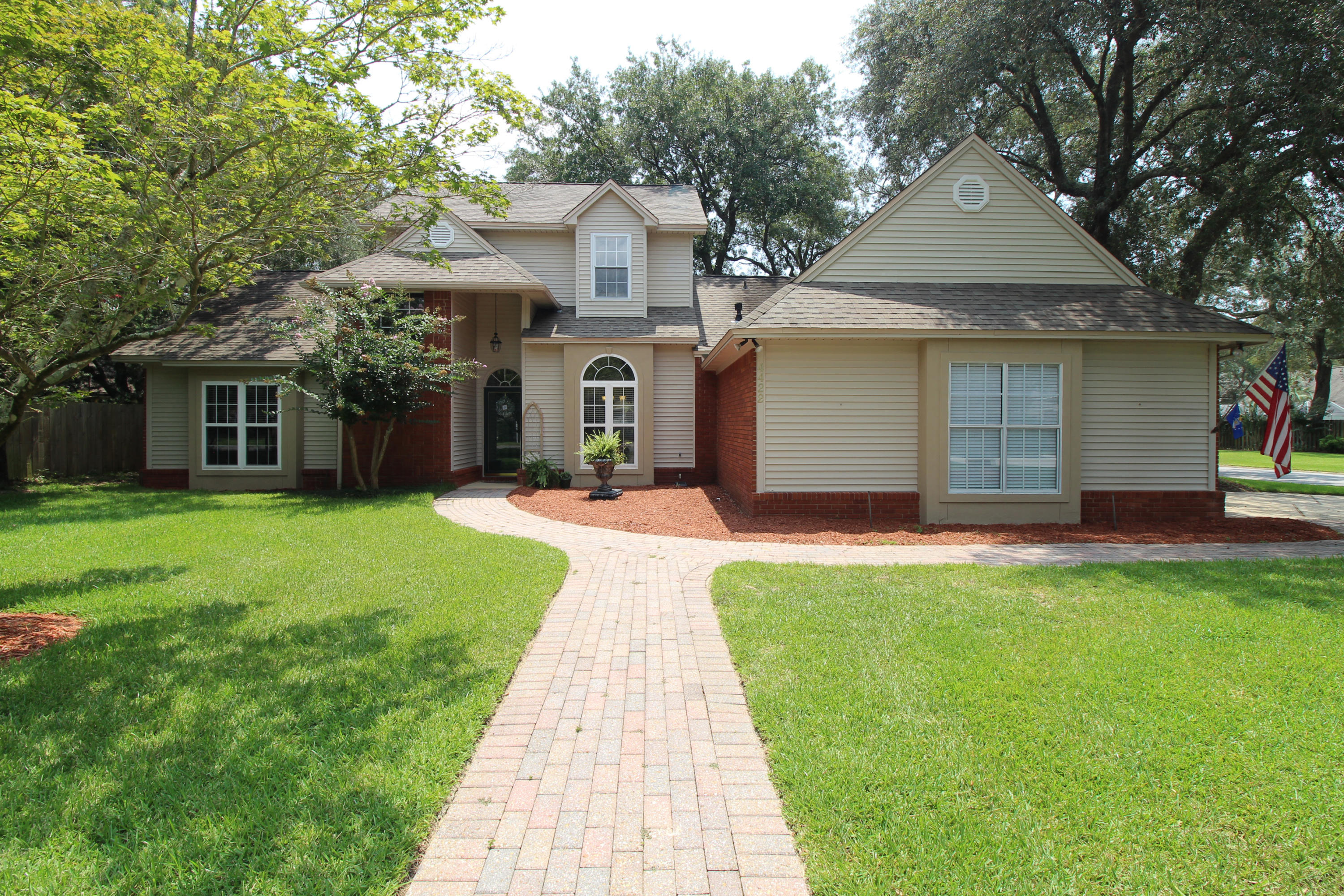 A beautiful corner lot setting for a beautiful home! Nestled in the gated community of Southwind, you will enjoy the beauty of the large, manicured lawn with paver sidewalk leading up to the front door and to the side entry of the two-and-a-half car garage.  This home has all the features you would expect of a custom home and more.  As you enter the house, you will admire the cathedral ceiling and openness of the first story, plenty of sunlight gleaming across the travertine floors.  Straight ahead is a spacious living room featuring 10' ceilings with crown molding, stately gas fireplace and graceful column with the formal dining area just off to your right.  Stepping thru an archway leads you to the open concept kitchen, family room, breakfast nook; a fantastic space for entertaining and gatherings.  The custom designed Kitchen boasts maple, soft-close cabinets, a custom hood vent over the island's smooth drop-in cooktop and granite countertop which overlooks the sunken family room.  Stainless steel appliances: Refrigerator with ice, built in microwave and oven, and a quiet dishwasher.  The view from the living room, kitchen, and breakfast nook boasts the picture-perfect lawn and a courtyard that gives an old Italian countryside villa flare.  The open patio is enhanced with brick pavers flower beds, twinkling over-hanging lights, fountain, and mature trees providing just the right amount of shade within the fenced-in yard.  Just off the Kitchen is the breakfast nook with a bay window providing access to the back yard.  The sunken family room has a stunning stone-surfaced fireplace from floor to the vaulted ceiling.  Back through the home just past the stairs is the double door entry to the grand Master Bedroom on the first floor.  The Master bathroom was remodeled with a soaking Victorian style claw bathtub and a separate glass surround shower.  His and hers vanity with custom cabinets to tuck away the toiletries.  Separate private commode and a walk-in closet.  Upstairs are two guest bedrooms with a jack-and-jill shared bathroom and each with walk-in closets.  Plenty of storage space above the master suit is accessible from the landing area.  There is a current Termite bond that can transfer to the new buyer.  Survey available. Laundry room can support either an electric or gas dryer.  Another natural gas stub out back can supply a grill. Roof is in fair condition installed in 2005, HVAC 2005, Water heater installed 2009.  Two-car garage with additional garage space for a mini car, golf cart or use as a workshop. Seller will provide a One year Home Warranty with acceptable contract.