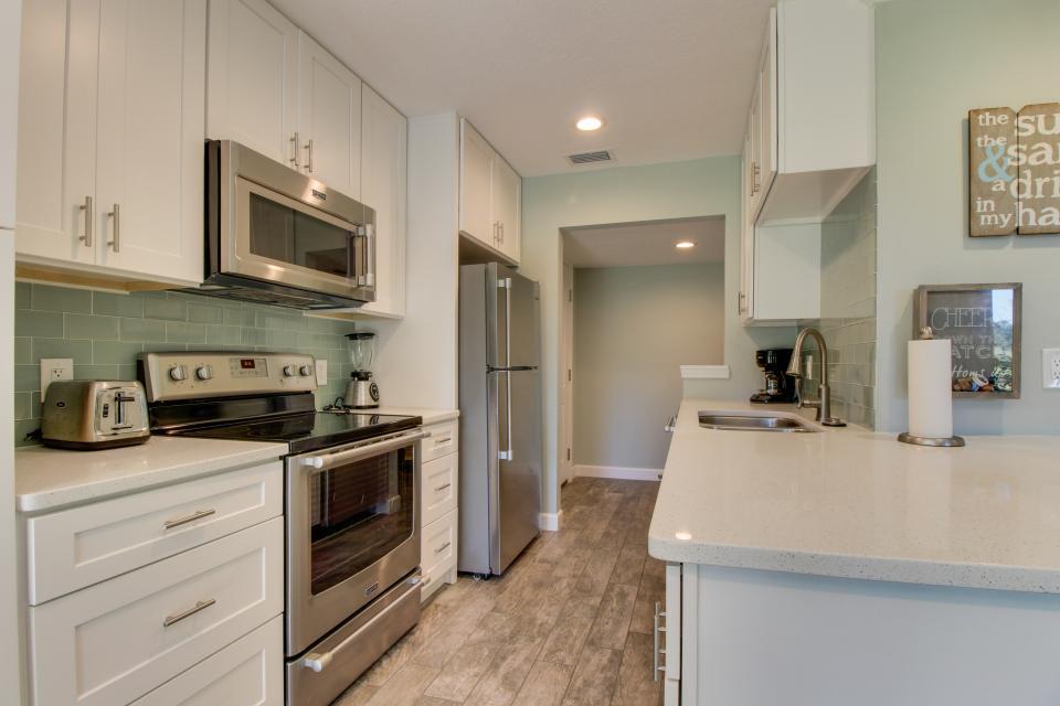 A newly remodeled condo located in the lush Seascape Resort is the slice of paradise you've been waiting for! This condo has had a massive renovation with new floors, furniture, cabinetry, bathrooms, kitchen and furniture and it feels like it is brand new! The kitchen features quartz counters, white shaker cabinetry, green sea glass backsplash and upgraded stainless steel appliances. The living room is spacious and overlooks the large porch and lush grounds of Seascape. The king sized master suite is beautifully decorated and has an en-suite bath with his/her sinks, quartz counters and a large walk-in shower with custom tile work. The guest bedroom is equally lovely and has access to the guest bath with quartz counter and fully tiled tub/shower with glass tile accents. Behind the guarded gates of the Seascape Resort, you and your guests will revel in the resort style amenities including 5 pools, 8 tennis courts, golf, on-site bike rentals, beach access, gates at both Scenic 98 and Hwy 98 for easy access and introducing the newest hot spot, Seacape Towne Center with some of the best restaurants and entertainment in the area!  You are also a quick drive to Silver Sands Outlet Mall and walking or quick car ride distance to other great restaurants and shops.