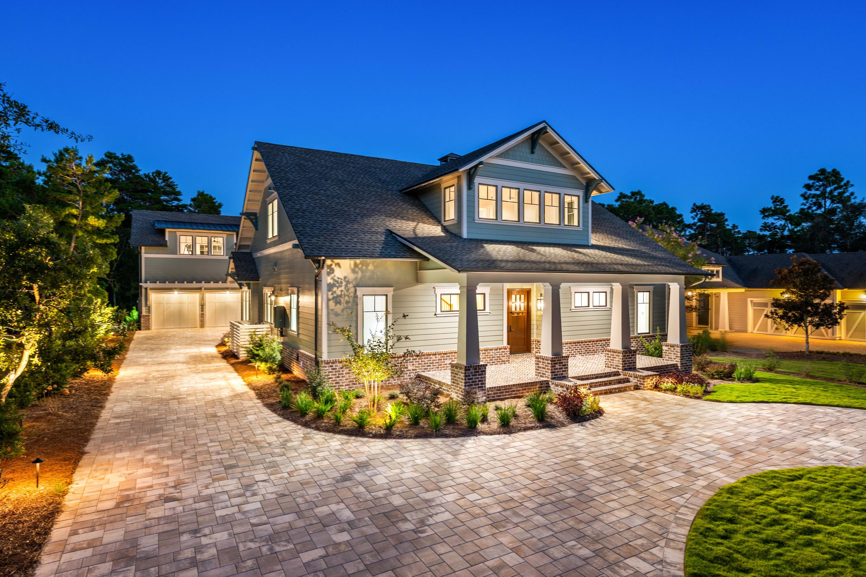 Brand New Construction with Screened-in Pool + Carriage House located on the 10th Hole of Shark's Tooth Golf Course in the coveted Gated Neighborhood of Wild Heron.
Masterfully combining timeless elegance with modern design, this craftsman home spans 3723 sqft offering 5 bedrooms + Loft Space, 4.5 bath, and an array of thoughtfully designed spaces tailored for both comfort and entertaining.
Outdoors, an oversized screened-in patio and pool area provide a private sanctuary, complete with a fully appointed Outdoor Kitchen with Bar Seating, separate dining space, and outdoor living room centered around a brick gas fireplace. 
The main level highlights an open-concept kitchen, living, and dining space that set the stage for entertaining. Custom in-set cabinets, quartz countertops, Wolf and quartz countertops, Wolf and Sub-Zero appliance package anchor the chef's kitchen and Butler's Pantry, seamlessly blending performance and design.
Shiplap walls frame the living and dining areas and echo the home's refined Craftsman character. Anchored by a gas fireplace, the expansive living room offers a serene and inviting atmosphere, perfect for both relaxation and entertaining. A conveniently located half bath serves the communal spaces, adding both comfort and practicality to the home's design.
Retreat into the sizeable main level Primary Bedroom, equipped with large Anderson sliding doors allowing for ample natural light and seamless indoor-outdoor living. The ensuite resort-like primary bathroom offers a statement garden tub, an elegant shower, dual vanities, and a built-out walk-in closet. 
Upstairs, you'll find three large bedrooms, including one with its own ensuite bath, along with a spacious loft that offers a flexible area to make your own. A generous hall bathroom serves the remaining bedrooms, providing both comfort and convenience for family and guests.
The oversized driveway allows for 10+ car parking not including the hidden two-car garage with a spacious carriage house above, offering versatile accommodations for guests, a private office, or additional living space.
Wild Heron is a 734-acre community with Coastal Craftsman Style on the shores of Lake Powell at Inlet Beach, Florida. Located just a short drive from world-class shopping, dining, the World's Most Beautiful Beaches of Panama City Beach, and the ever-popular 30A Beaches of South Walton County. The community offers a plethora of amenities, including a lakeview swimming pool, health & fitness center, boardwalks and nature paths, parks and lakefront Boathouse with kayaks and canoes. Owners at Wild Heron can opt to join the WaterSound Beach Club offering members exclusive access to Shark's Tooth Golf Course, The Third Golf Course, Camp Creek Golf Course, Camp Creek Ammenties Center, and the WaterSound Beach Club for private beach access and its multiple pools and restaurants.