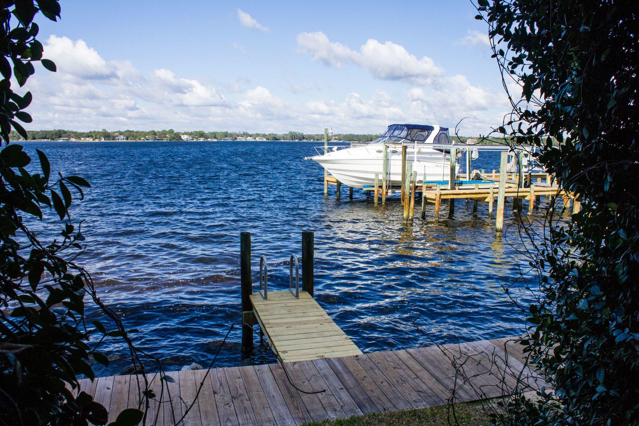 You don't want to miss this one! Incredible Water front views from every floor. If you want waterfront living-THIS IS WHAT YOU WANT. DEEP WATER BOAT SLIP INCLUDED. When you walk in from your foyer you see a bedroom or a game room straight ahead of you. Garage-yes, Your garage is to your right and stairs that lead upstairs are to your left. You have a full bath down stairs with plenty of storage. Large sliding glass doors that lead out to your covered deck-WITH UNOBSTRUCTED VIEWS OF GARNIERS BAYOU. On the second level you have an open floor plan with large sliding glass doors that lead out to another large covered deck over looking the bayou. Family room with a dining area and kitchen. All open-you can see the water from every room. Large open kitchen with stainless steel appliances. There is a half bath also on this floor. On the third floor is the Master, you have fantastic views from your bedroom with sliding glass doors that lead out to another covered deck. Glass french doors are what separates the bedroom from the master bath. The master bath has a double vanity, large walk in shower and a large walk in closet. There is another bedroom on this level with it's own bath. THIS IS WHAT PEOPLE DREAM OF WHEN THEY TALK ABOUT WATERFRONT LIVING WITH A BOAT!!!! This complex is small, close to everything but tucked away to provide the seclusion you want in a home. Check this unit out today