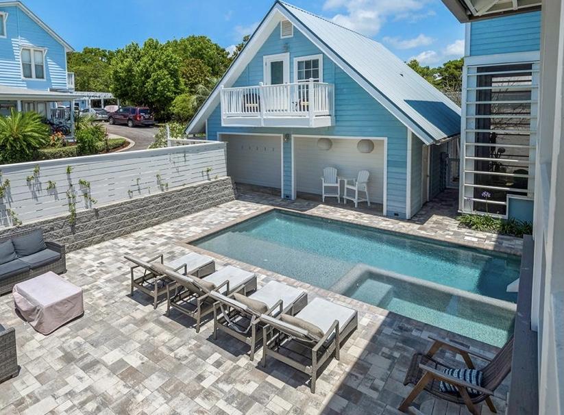 This stunning beach house with just under 4,200 sq ft of living space (6493 sq ft under roof) including the carriage house is just 2 blocks from the beach and perfect for entertaining. The main house includes 5 bedrooms, 4 bathrooms, a huge garage with 14' ceilings (big enough for an RV), open concept living areas and a brand new patio, heated pool, hot tub & outdoor shower. The gorgeous kitchen has stainless steel appliances, a large gas range, pot filler, walk-in pantry and wine cooler. The living and dining room offer space for the whole family to gather with a 72' linear gas fireplace. The carriage house is a free standing one bedroom, one bathroom apartment with a full kitchen. The property received a major renovation in 2021 to become a highly desired vacation home. No HOA!!!