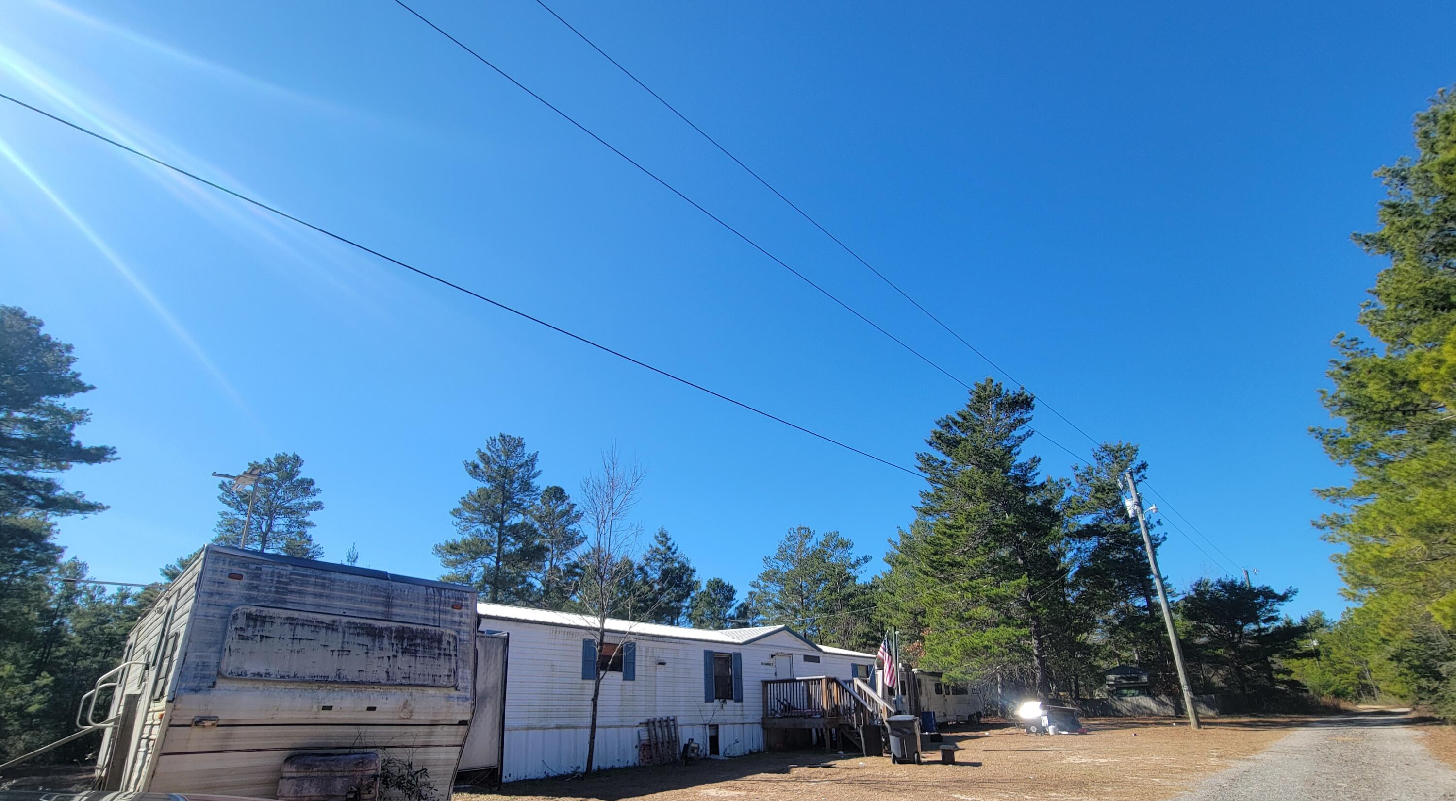 Super Buy Fixer Upper! CASH SALE only!  Property being sold in 'AS IS' condition.  This 3 bedroom 2 bath appx. 1,344 sf. in this 1988 manufactured home.  Home had new metal roof installed 3 years ago.   There are 8 lots included in the sale (25' x100' each) totaling appx. .50 acres.   'Affordable  Find' for those looking for an investment near I-10.  Click on  'Documents'  for a copy of the plat.