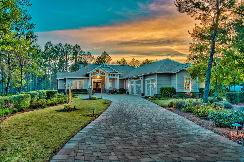 Hard to find, beautifully styled craftsman ranch home, by Ledman Construction, in the coastal sanctuary of Wild Heron. Newer construction, with up to date finishes and packed with custom features. Enter your new beautiful custom home through the mahogany front doors with artisan leaded glass. Take in the decorative molding, beautiful flooring, plantation shutters and 12-foot coffered ceilings in the living room. For greater creature comforts, the homes wood-burning fireplace is surrounded by a Medusa stone mantle, with over sized, back-lit, antique Indonesian wooden doors adorning each side. This home has a private office/den with a custom standing treadmill desk however; this office could be used as a media room. This open and split floor plan; four-bedroom, three-and-one-half bath home, is designed with extra space to accommodate wheelchair access throughout. Spacious and comfortable, the exceptional design delivers an eloquent flow, making it cozy for coastal living and ideal for entertaining. The chef's kitchen is loaded with features: two large islands with an abundance of custom cabinets, granite countertops, 48" gas stove with electric double ovens and, a dry bar with wine refrigerator for serving perfectly chilled drinks. Stainless steel Kitchen-Aid appliances and a reverse osmosis Culligan water system, provide added benefits. The oversized 8' sliding glass doors give seamless access to the screened porch and patio for relaxing and watching the sunset. The half-acre lot backs onto a peaceful preserve and has space for a pool. Beautifully landscaped gardens line the paved driveway to the handsome three-car oversized garage, which includes golf cart parking and useful added storage. Ownership of this home includes access to Panama City Beach's dune lake, Lake Powell, the Wild Heron community pool and private health and fitness club, as well as the many walking trails that meander through the community.  Enjoy kayaking, paddle board or sailing in the pristine waters of this coastal dune lake or hop on the pontoon boat for a ride to Camp Helen, to walk the white sugar beaches and dip your toes into the gulf.  Cool off in the community pool or unwind in the hot tub. Enjoy sunsets at the fire pit and take tranquil walks on the many trails, meandering through the community.  Golfers will be impressed by the award-winning Greg Norman Shark's Tooth Golf Course, private clubhouse and the Har-Tru tennis courts (private membership required).  No longer will you have to endure "temporary tourists" invading your property.  Wild Heron is a private gated community with 24hr security, fronting Lake Powell. That means, with ownership, comes the serenity that only the Wild Heron Community can offer.  You will not have to fight the seasonal throngs that invade some of the other properties along 30A.  You own your own slice of paradise.  If you seek your own private paradise built in a beautiful one of a kind sanctuary, your keys are waiting, call today to schedule a showing.  Buyer should verify all data and dimensions.