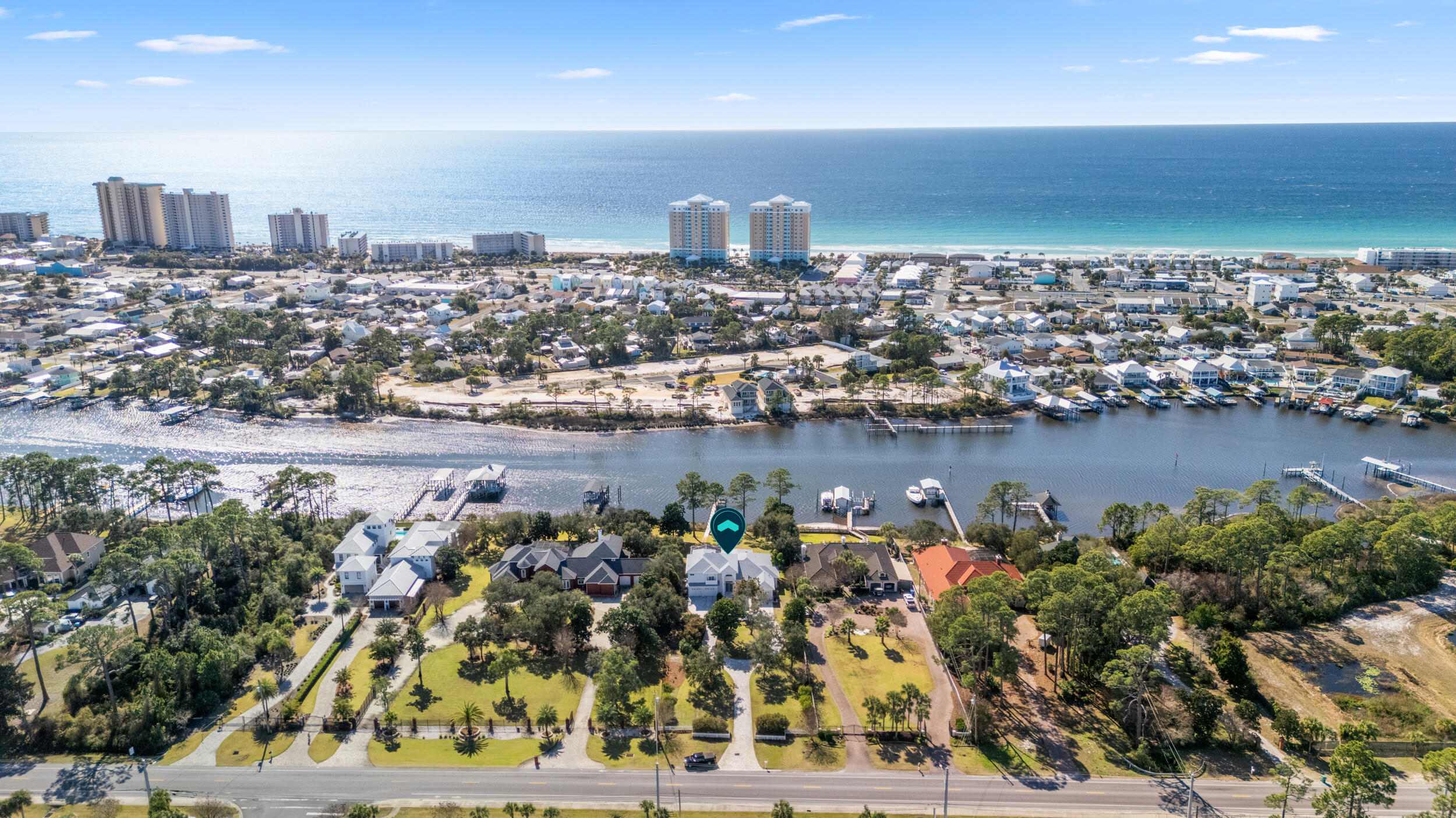 A rare and luxurious waterfront offering, this stunning lagoon-front residence sits on just under 1 acre, delivering privacy, breathtaking views, and an elevated coastal lifestyle. Encompassing 3,384 square feet, this 4-bedroom, 3.5-bath residence is filled with soaring ceilings, expansive windows, and an abundance of natural light that frames the serene lagoon from nearly every room. Designed for both elegant living and entertaining, the home features a remodeled kitchen that serves as the heart of the residence perfect for hosting gatherings while enjoying water views. Light pours into the living spaces, enhancing the open feel between indoor and outdoor living. The home offers three gas fireplaces, adding warmth and ambiance throughout. All windows and doors have been replaced with hurricane rated systems installed to current code. The roof was replaced in May of 2024 and includes a 10 year workman warranty. The outdoor setting is equally impressive, highlighted by a large, private pool and a dock with the potential to create a custom boat oasis. Whether relaxing poolside or launching a day on the water, the backyard provides a tranquil and luxurious escape. The entire second floor is dedicated to the primary suite, offering a private retreat complete with a spacious bedroom, en-suite bath, and a private balcony that is great for enjoying a morning coffee or watching unforgettable sunsets over the lagoon. Upon arrival, the home makes a striking first impression with a beautifully landscaped front yard, and mature trees. A 3-car garage offers generous space for vehicles or storage, adding both convenience and versatility. With its commanding waterfront presence, refined interior spaces, and exceptional outdoor potential, this extraordinary property presents a rare opportunity to own a truly refined lagoon-front retreat. Information contained within this listing such as lot dimensions, is deemed to be accurate but is not guaranteed. Buyer to verify.