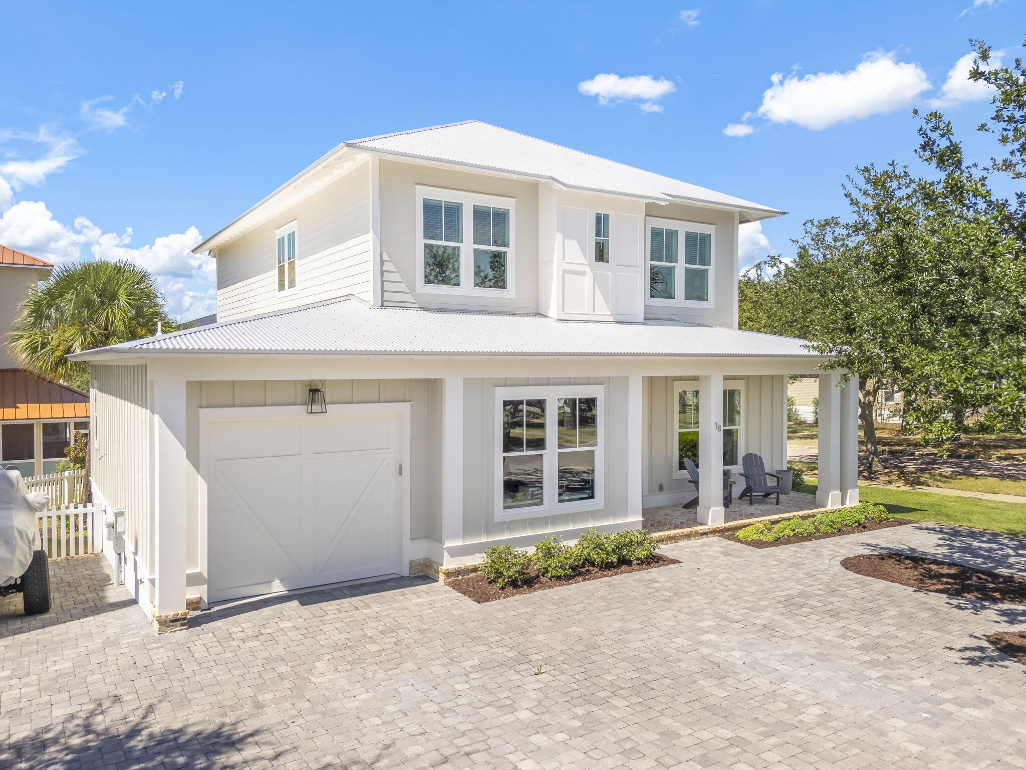 Welcome to 18 Heidi Heights Drive, a custom-built home in a gated community just a short walk from the beach. Every inch of this property reflects thoughtful design and timeless craftsmanship, with upscale finishes and upgrades in every room.

From the 10-foot ceilings and crown molding throughout to the curated mix of accent walls featuring shiplap, wallpaper, and reclaimed Old Chicago brick, the attention to detail is obvious. Both the front and back porches are finished in the same reclaimed brick, creating a warm, welcoming first impression and a lasting sense of quality.

The open-concept kitchen, dining, and living areas create an inviting space perfect for gathering and entertaining. The dining area features a striking brick accent wall with a sliding barn door, adding both character and functionality by creating privacy from the entry. The kitchen is a true showpiece, complete with a coffered ceiling, an oversized 11x4 island with built-in storage, cabinetry with pull-out shelves, an appliance lift, and under-cabinet lighting. The living area includes built-in bookshelves and offers a seamless flow that feels both spacious and comfortable.

With four spacious bedrooms, each featuring its own private en suite and custom closet, this home offers both comfort and functionality. There's also a versatile bonus room with cubbies and a separate room off the garage with built-in desks and shelving, perfect for a home office, study area, or craft room.

Designed with full-time living in mind, this property provides abundant storage options, including an oversized single-car garage, parking for up to seven vehicles, and a fenced backyard. An additional storage area beneath the back porch is ideal for kayaks, paddleboards, or beach gear.

The Village at Blue Mountain is a gated neighborhood that offers resort-style amenities just steps from your front door. Enjoy a large community pool, a fully equipped fitness center with machines and free weights, shuffleboard, a putting green, and bocce ball courts. At the neighborhood entrance, you'll find a variety of local dining options, including Mimmo's Italian restaurant, an ice cream shoppe, a coffee bar, and a Thai restaurant. More beloved spots like Red Fish Taco with live music, McTighe's Irish Pub, and Cowgirl Kitchen add to the vibrant local scene, all within easy walking distance. Best of all, this home includes deeded beach access less than half a mile away. Additionally, The Village at Blue Mountain Beach has access to both Highway 30A and 83, making it easy to explore everything the Emerald Coast has to offer.

This home is truly one to see to appreciate. Every detail has been carefully selected to create a space that's both beautiful and livable, just minutes from the sugar-white sands of the Gulf.
