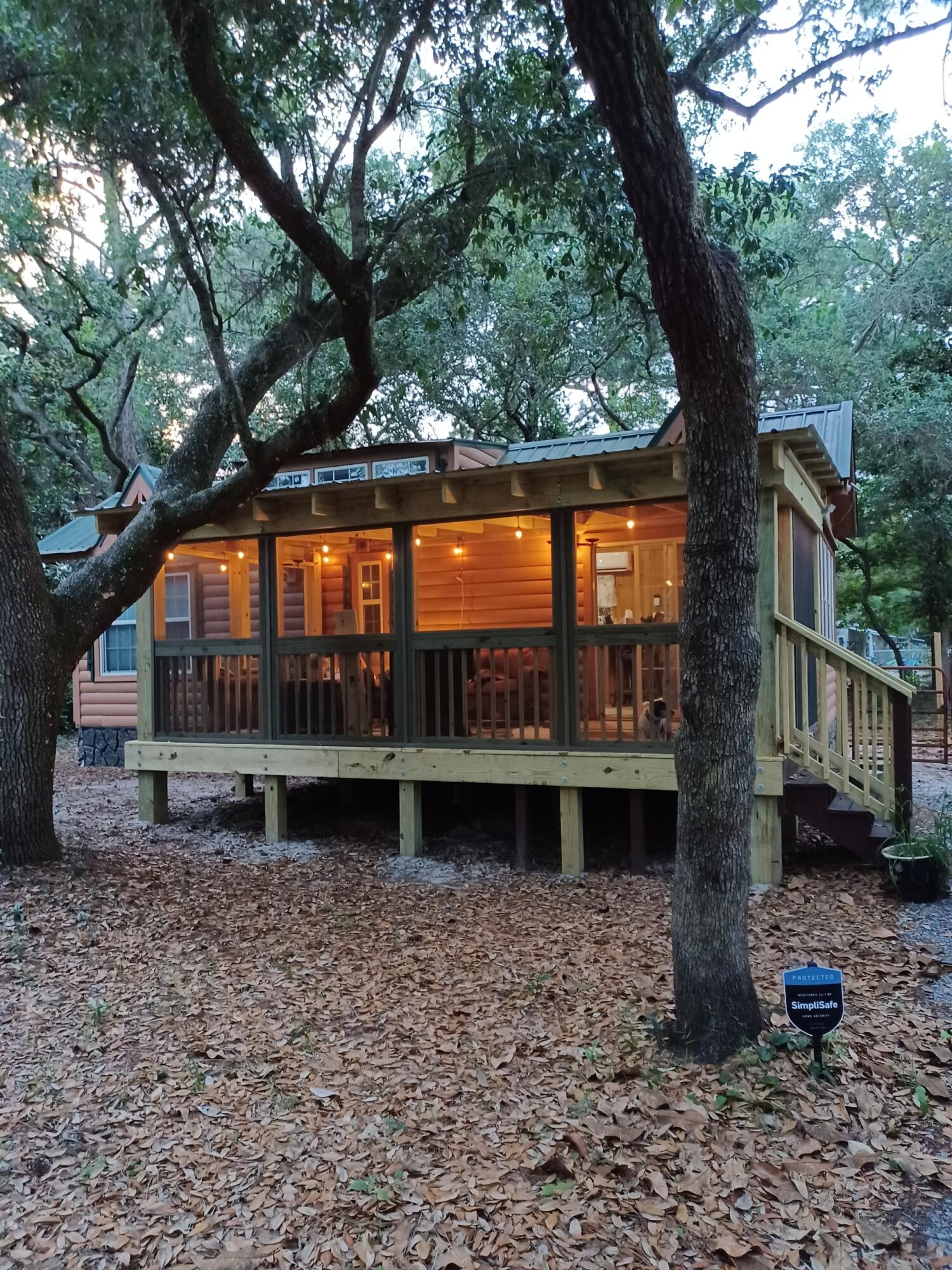 Discover your cozy retreat in this delightful 551 sq ft tiny home nestled in the serene woods of Santa Rosa Beach. Perfect as a personal getaway or a unique investment opportunity.

Features:
- 1 Bedroom: Comfortable and inviting space.
- Loft: Ideal for extra sleeping space or storage.
- Full Bathroom: Modern and well-appointed.
- Living Room: Bright, welcoming, with vaulted ceilings.
- Kitchen: Efficient with ample storage.
- Screened-In Porch: Enjoy the outdoors without the bugs.
- Rustic Charm: Wood exterior and green metal roof blend with nature.

Interior Highlights:
- All-wood design with natural wood paneling.
- Large windows for abundant natural light.
- Ceiling fan for added comfort.

Set on a wooded lot, this home offers privacy and a peaceful atmosphere.