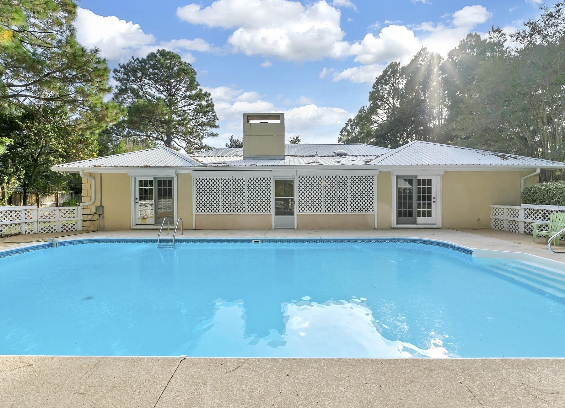 Opportunity to own a home in Santa Rosa Ridge; located on nearly 1/2 acre lot (1.5 lots) within a mile of the Gulf of Mexico.  Eat in world class restaurants, or spend your afternoon soaking up the sun at one of the white sandy beaches along 30A.  Lounge on the massive 36' by 62'private pool deck or enjoy breezes on the screened patio. Relax on an open patio along the front of the home adjacent to the covered porch entrance.  Enter the generous foyer to find a living room with two sets of French doors leading to the screened porch.  Plenty of storage in the oversized master bedroom closets as well as en-suite master bath.   Hall bath features a walk-in shower (handicap accessible).  Cozy up to a fireplace in the family room with breakfast bar or living room.   As-Is with Right to Inspec